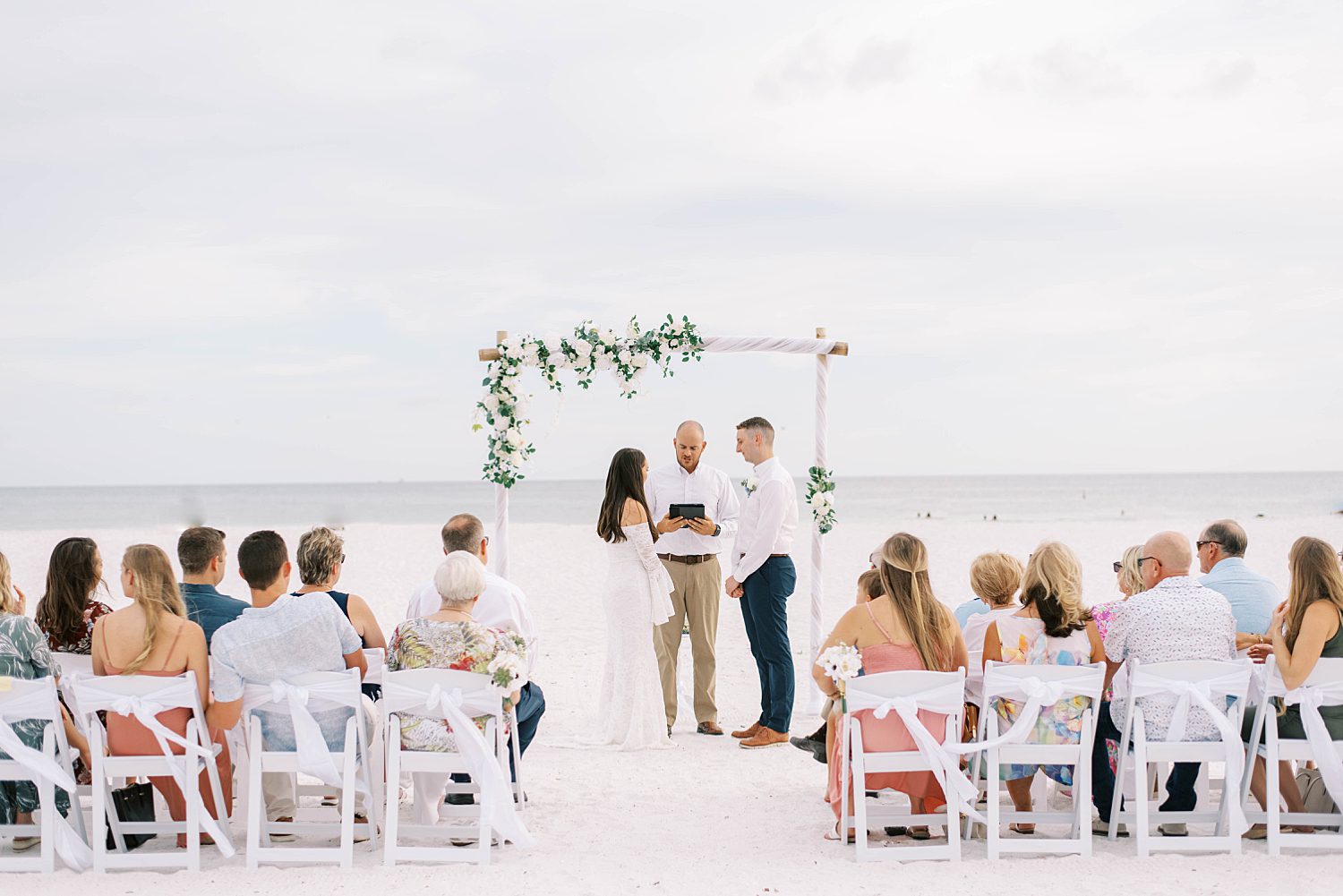 bride and groom exchange vows during beach elopement in Florida 