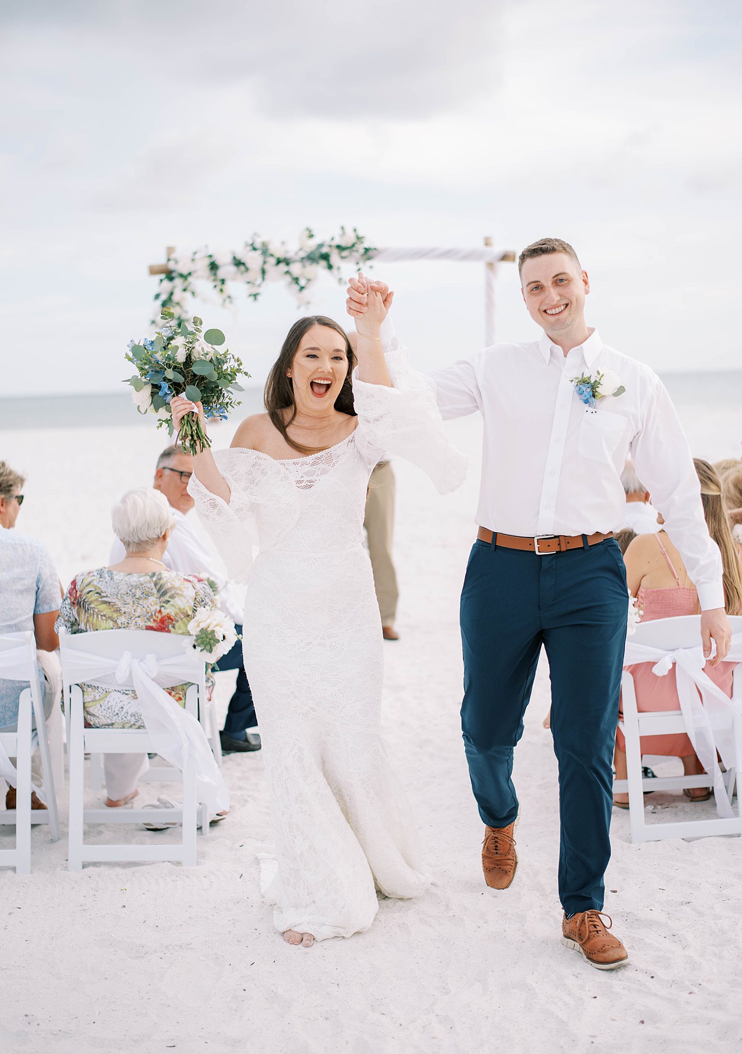 bride and groom cheer during Lido Key Beach elopement 