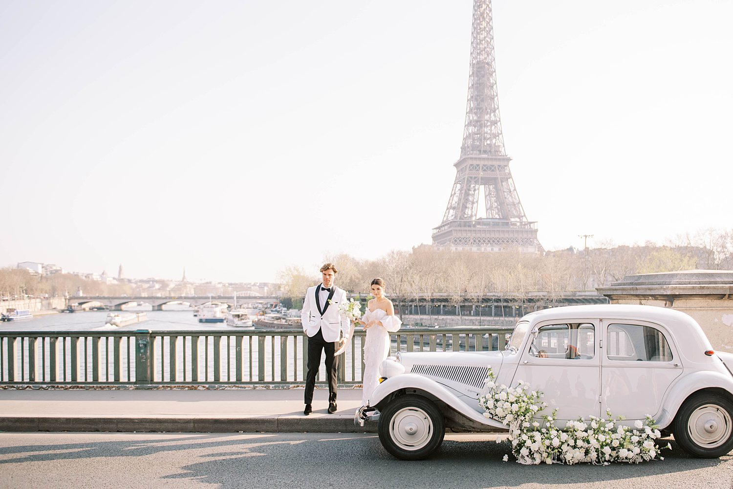 bride and groom stand along waterfront in Paris