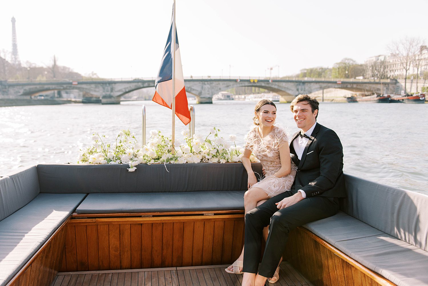 newlyweds laugh during boat wedding reception on River Seine 