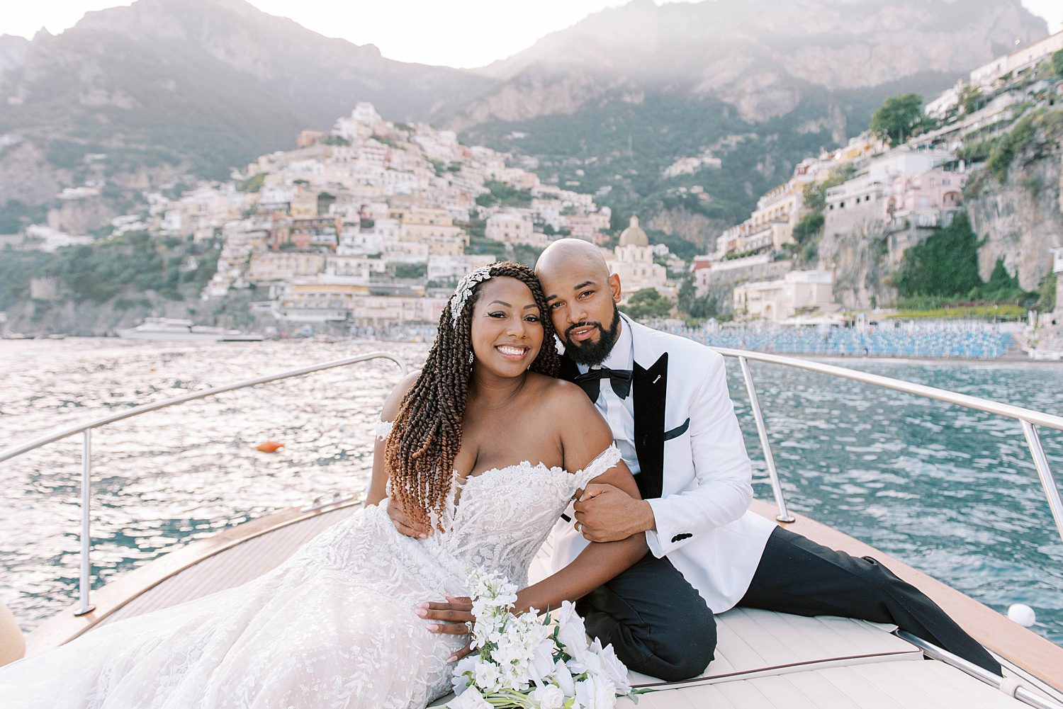 newlyweds sit on front of boat during Amalfi Coast elopement