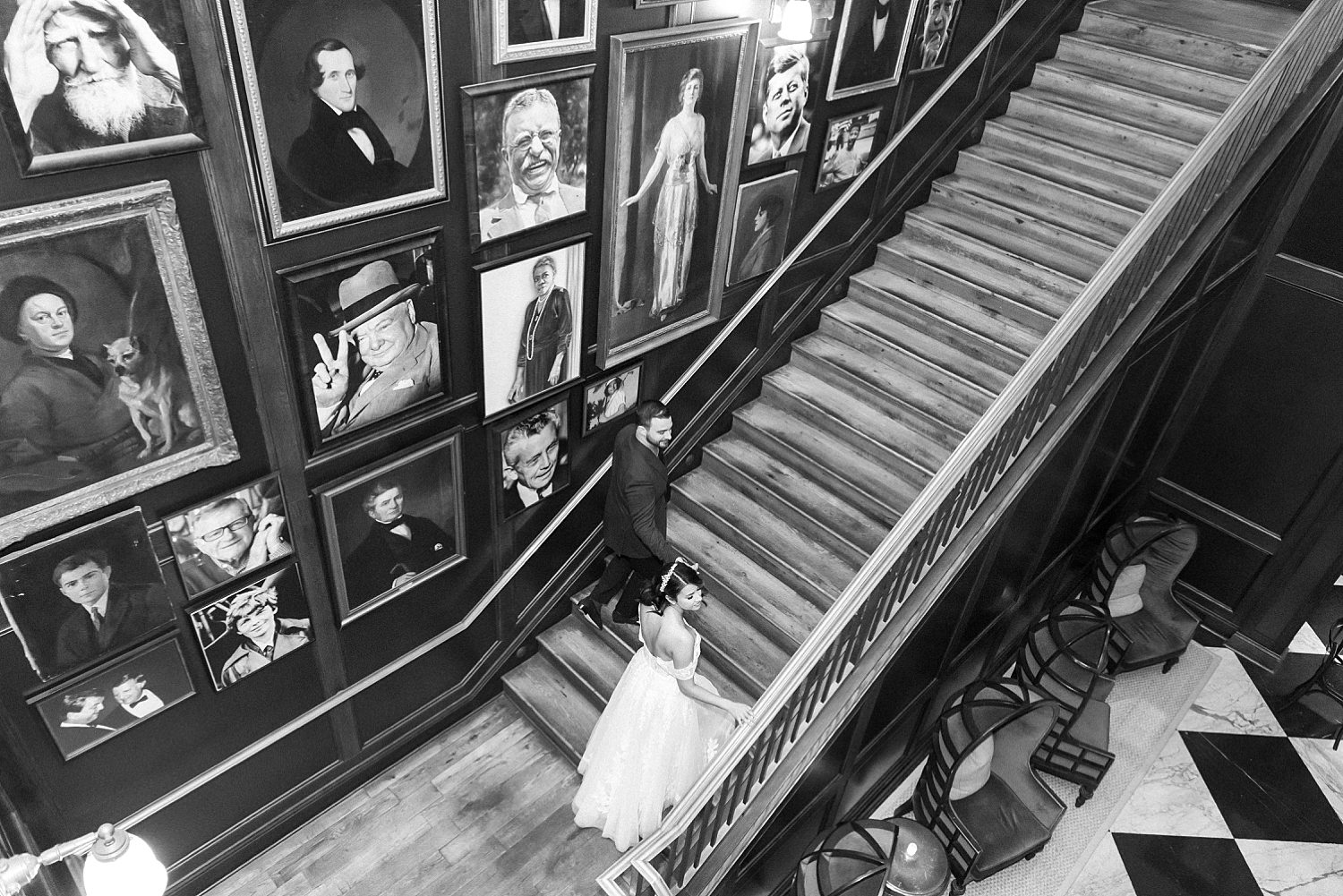 black and white portrait of bride walking up steps inside Oxford Exchange
