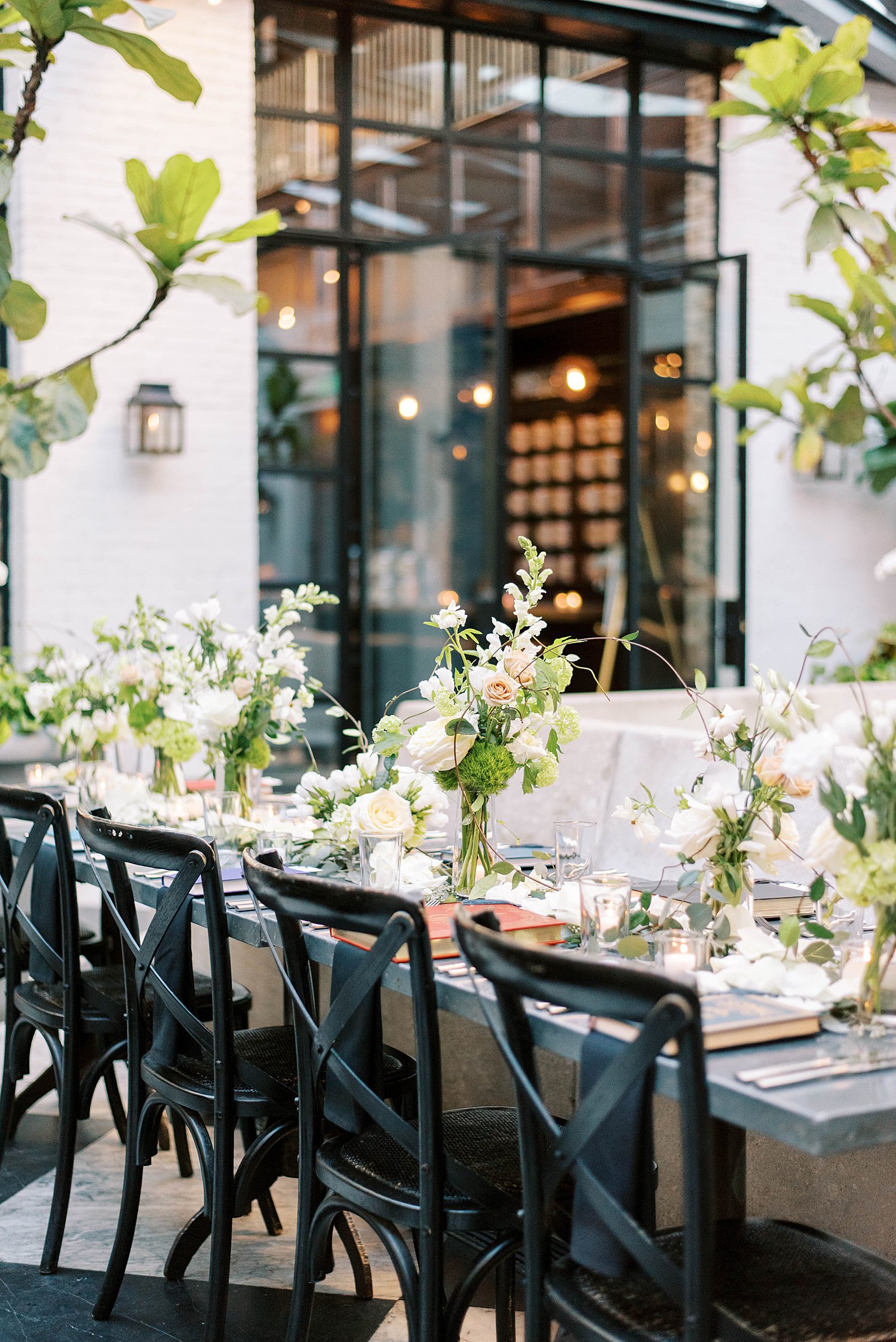 wedding reception at Oxford Exchange with long table and floral arrangements