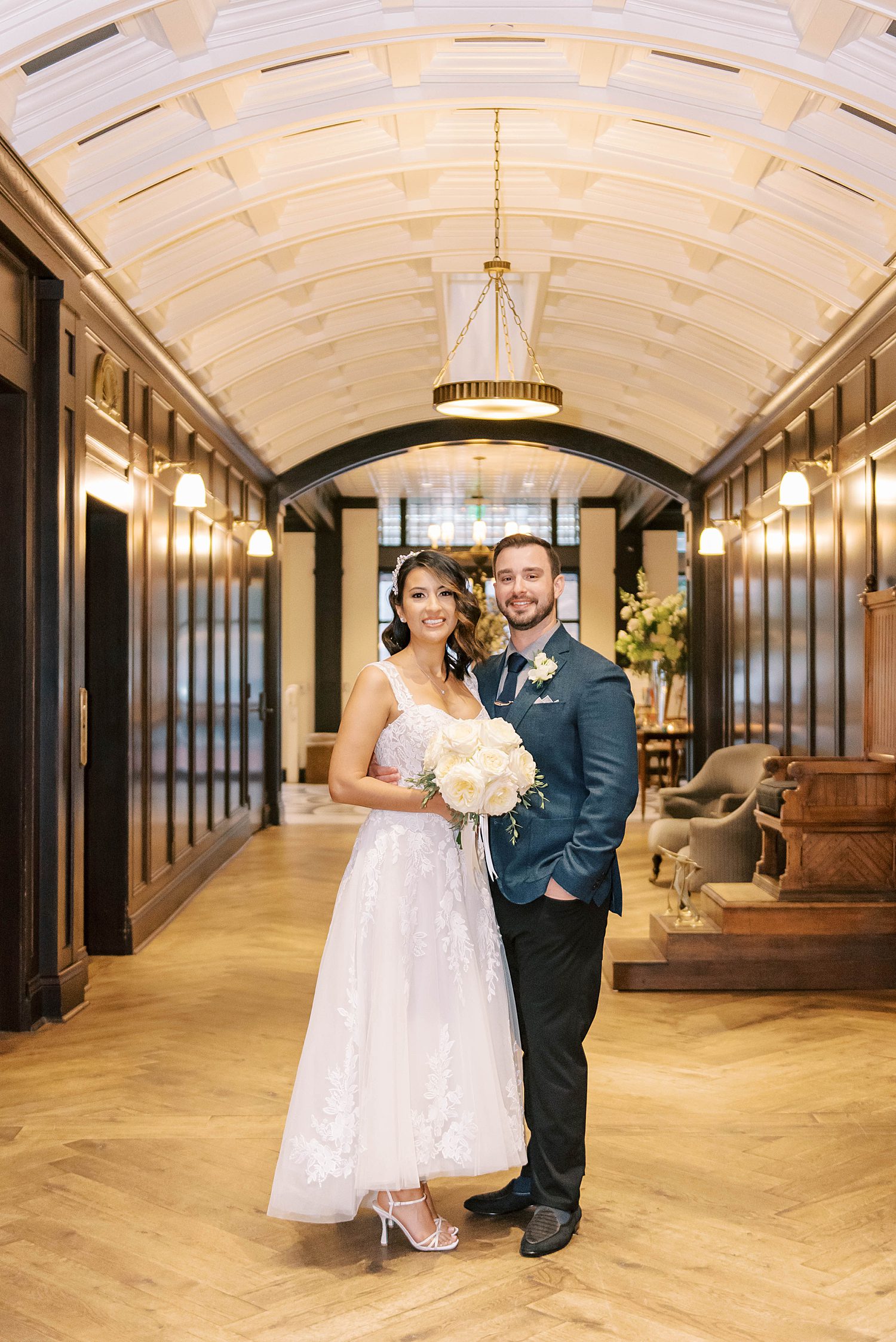 newlyweds hug in hallway at Oxford Exchange