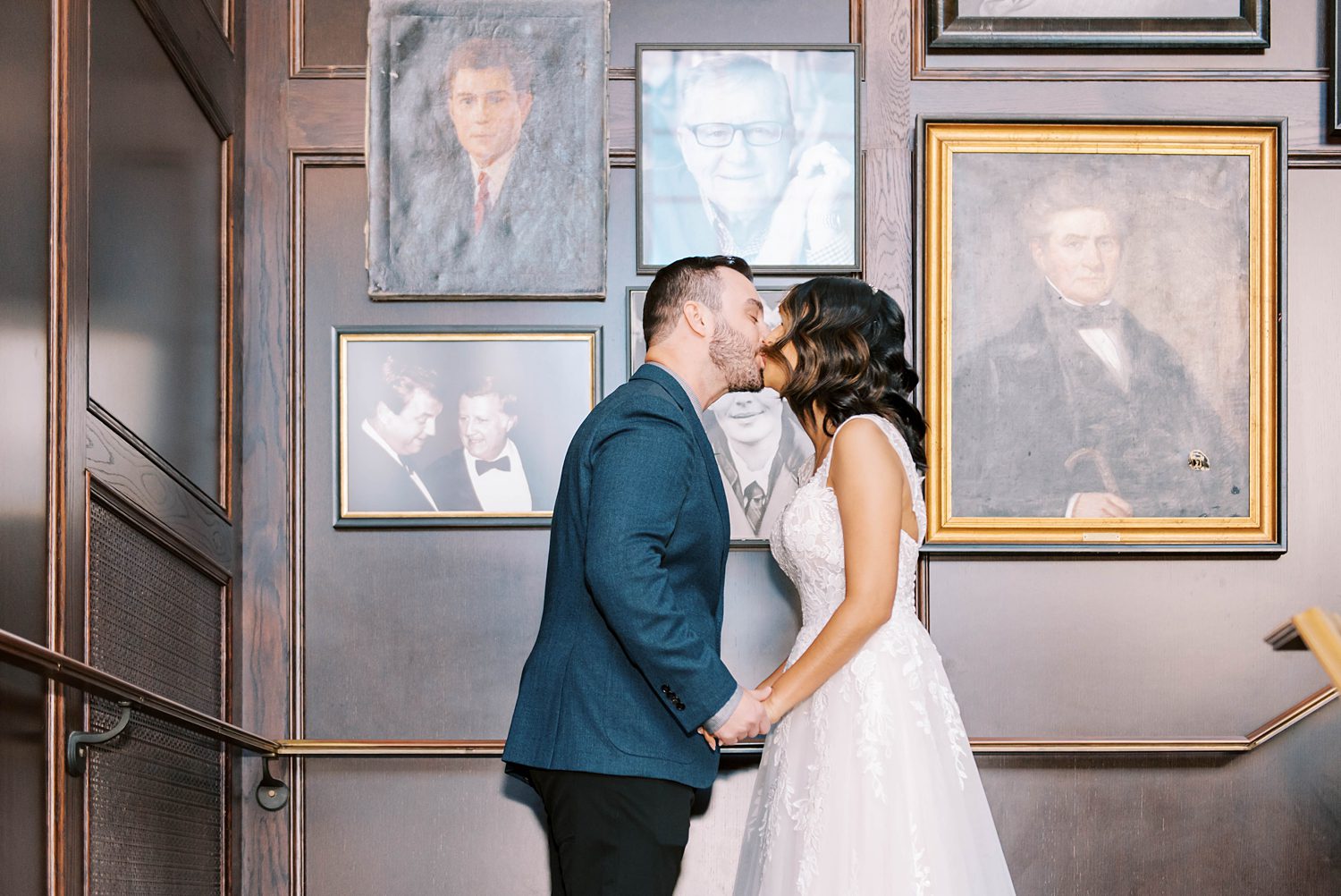 newlyweds kiss during ceremony on steps at Oxford Exchange