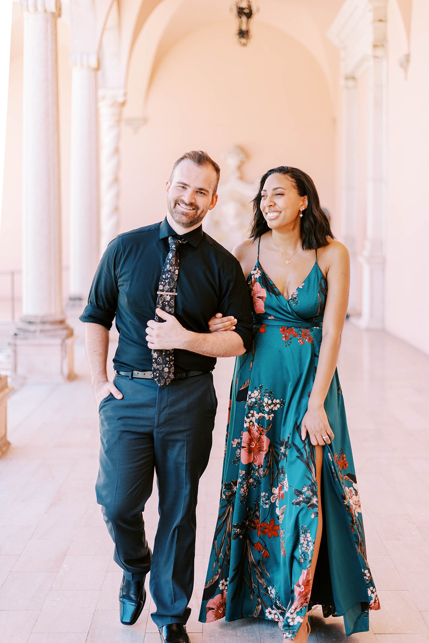 man walks with woman on his arm during portraits at the Ringling Museum