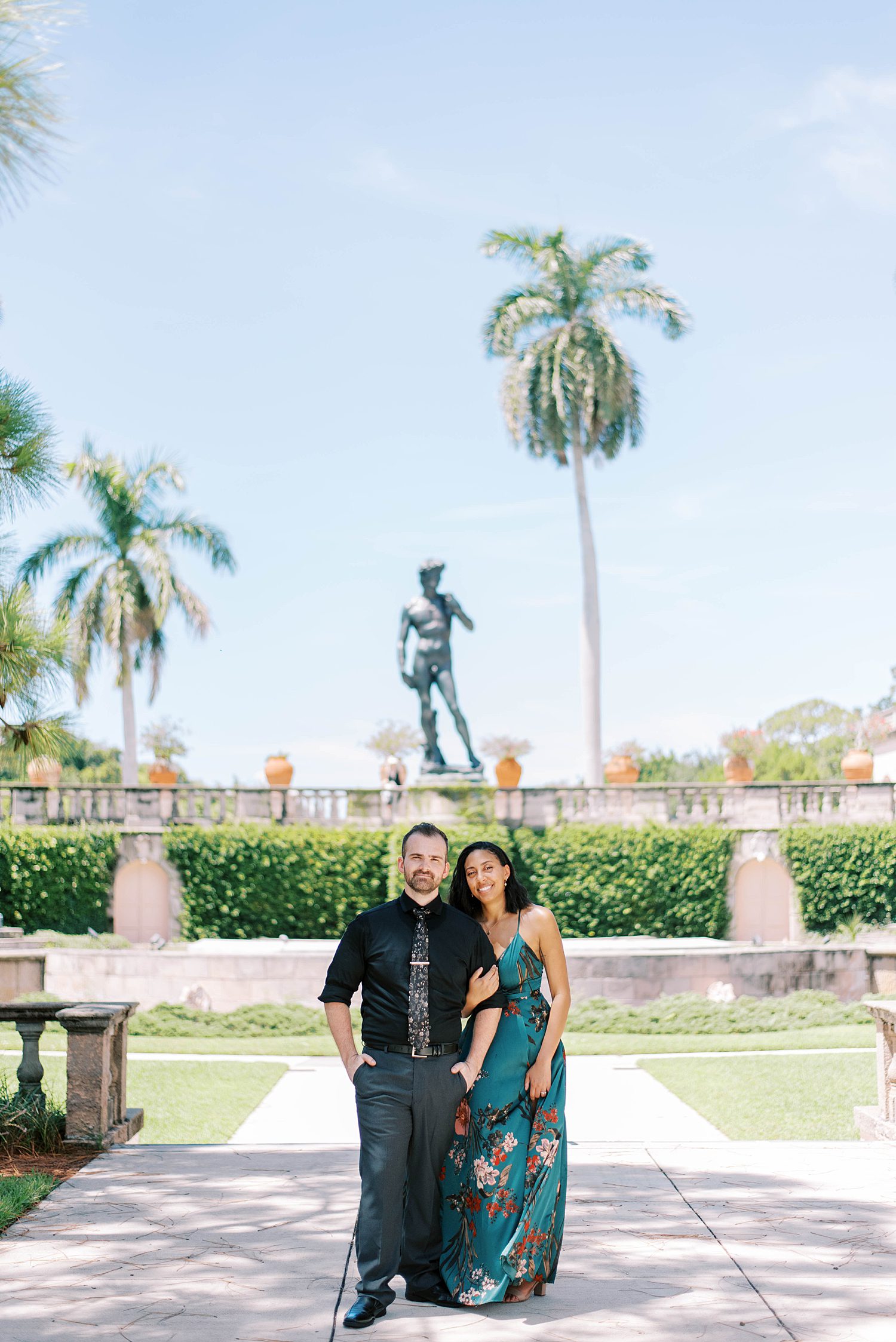 bride and groom pose in gardens at the Ringling Museum
