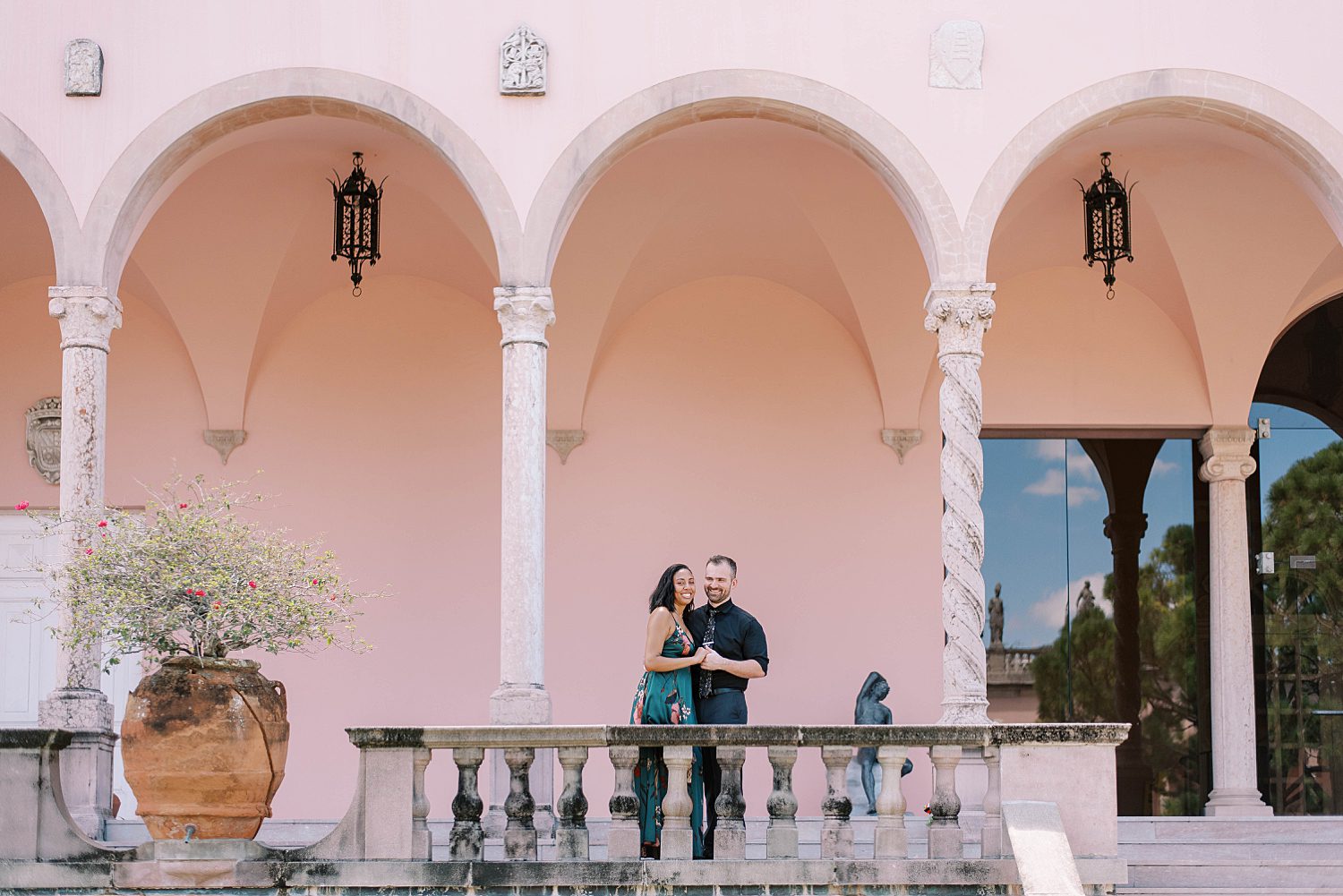 engaged couple hugs on balcony at the Ringling Museum
