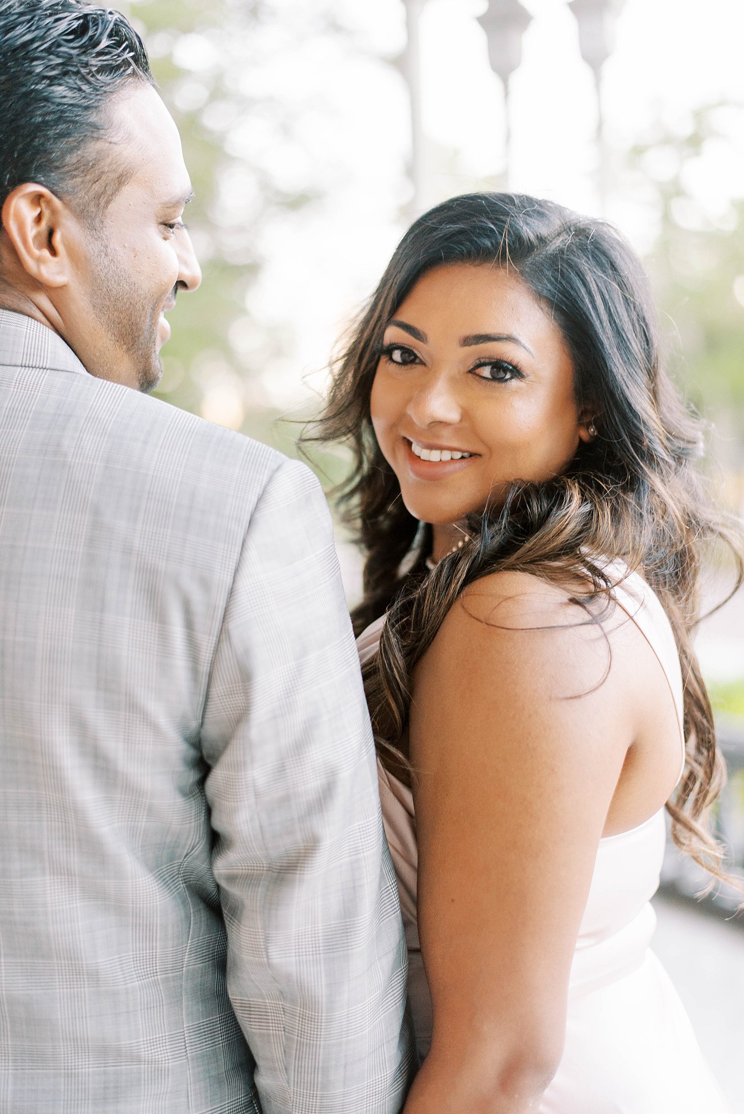woman looks over shoulder smiling during University of Tampa engagement session