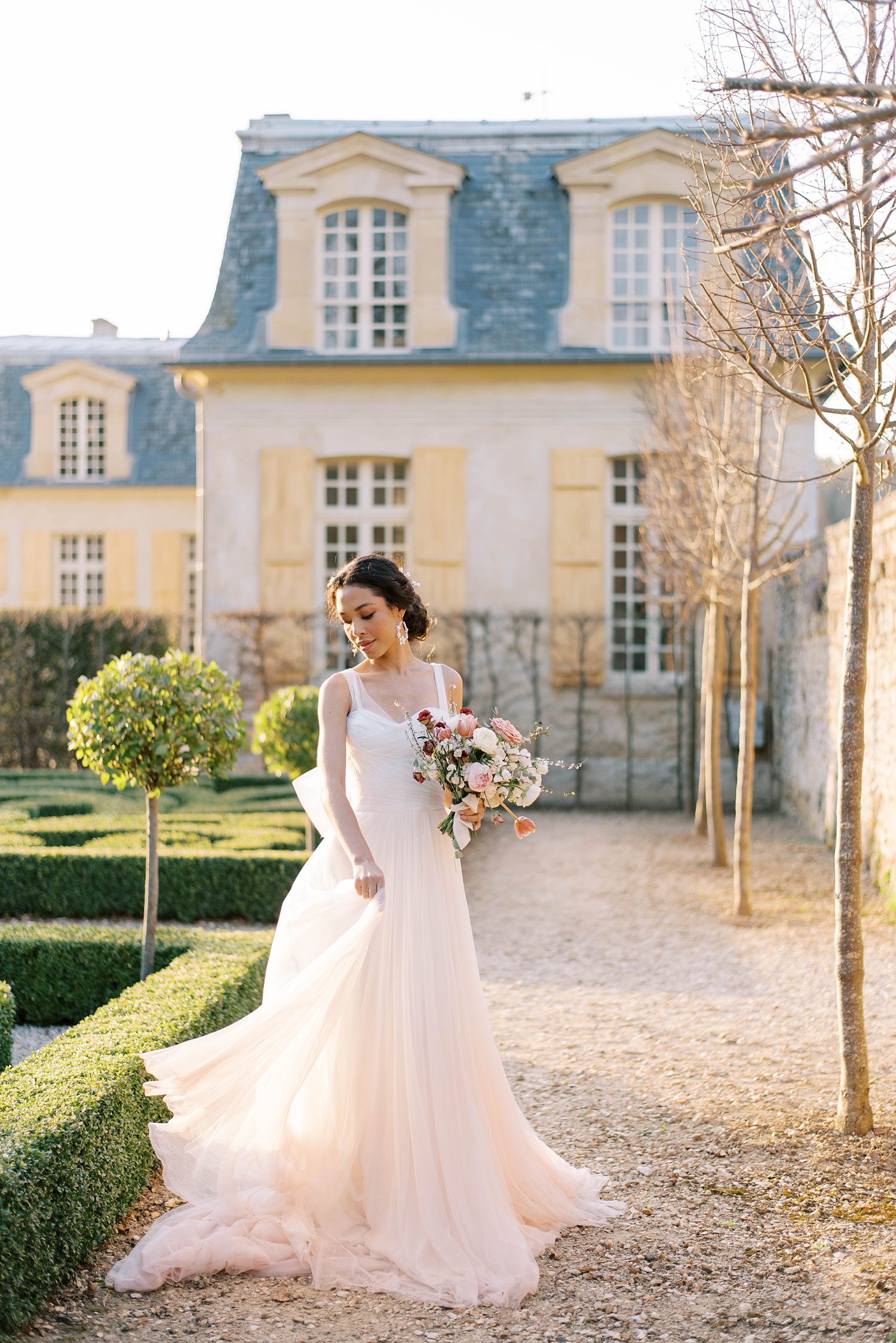 bride twirls in pink wedding gown