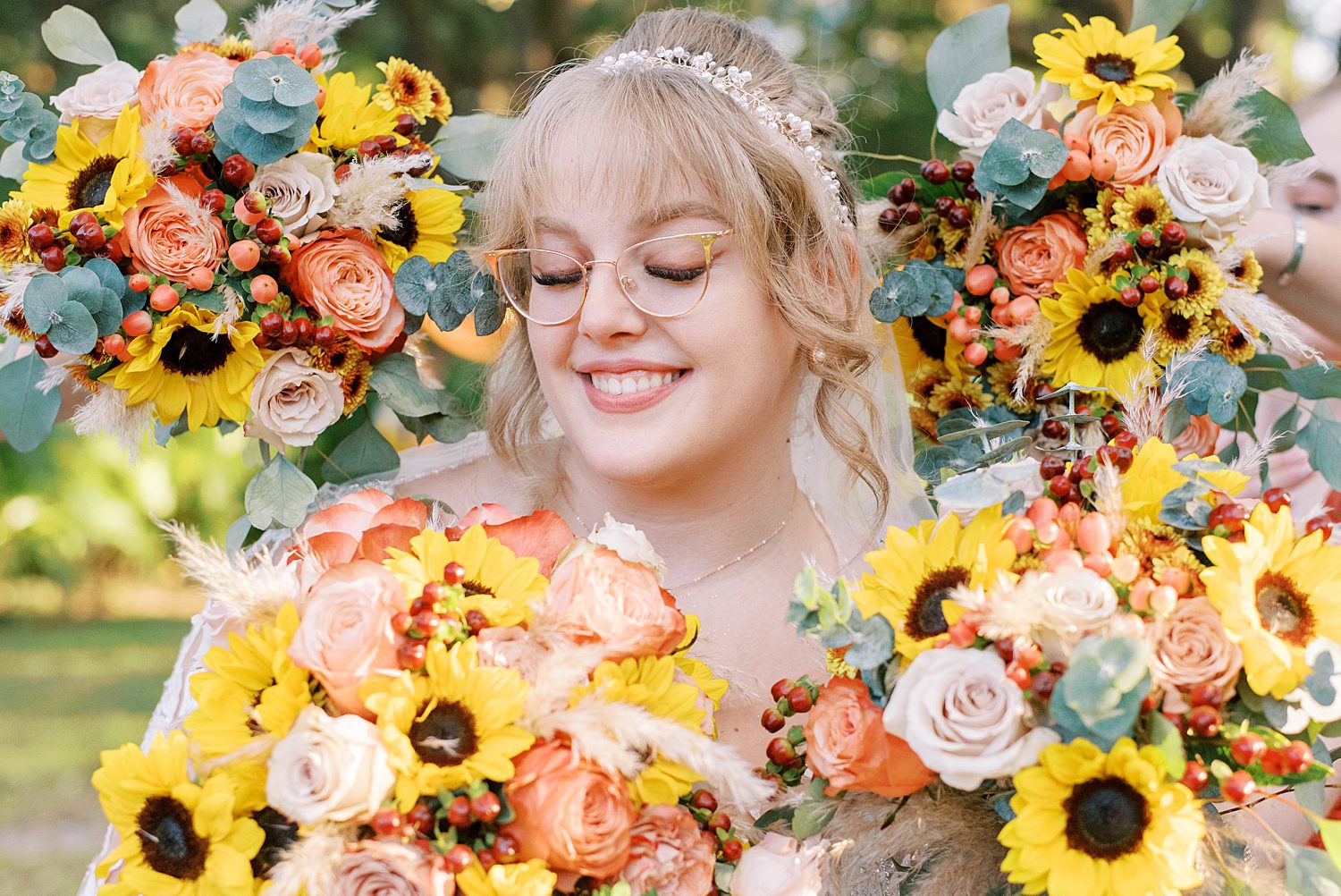 bride stands with bouquets around her at Events Under the Oaks