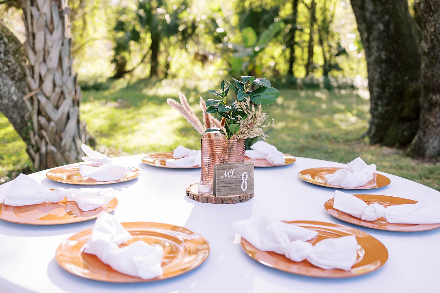 wedding reception at Events Under the Oaks with orange and green flowers 