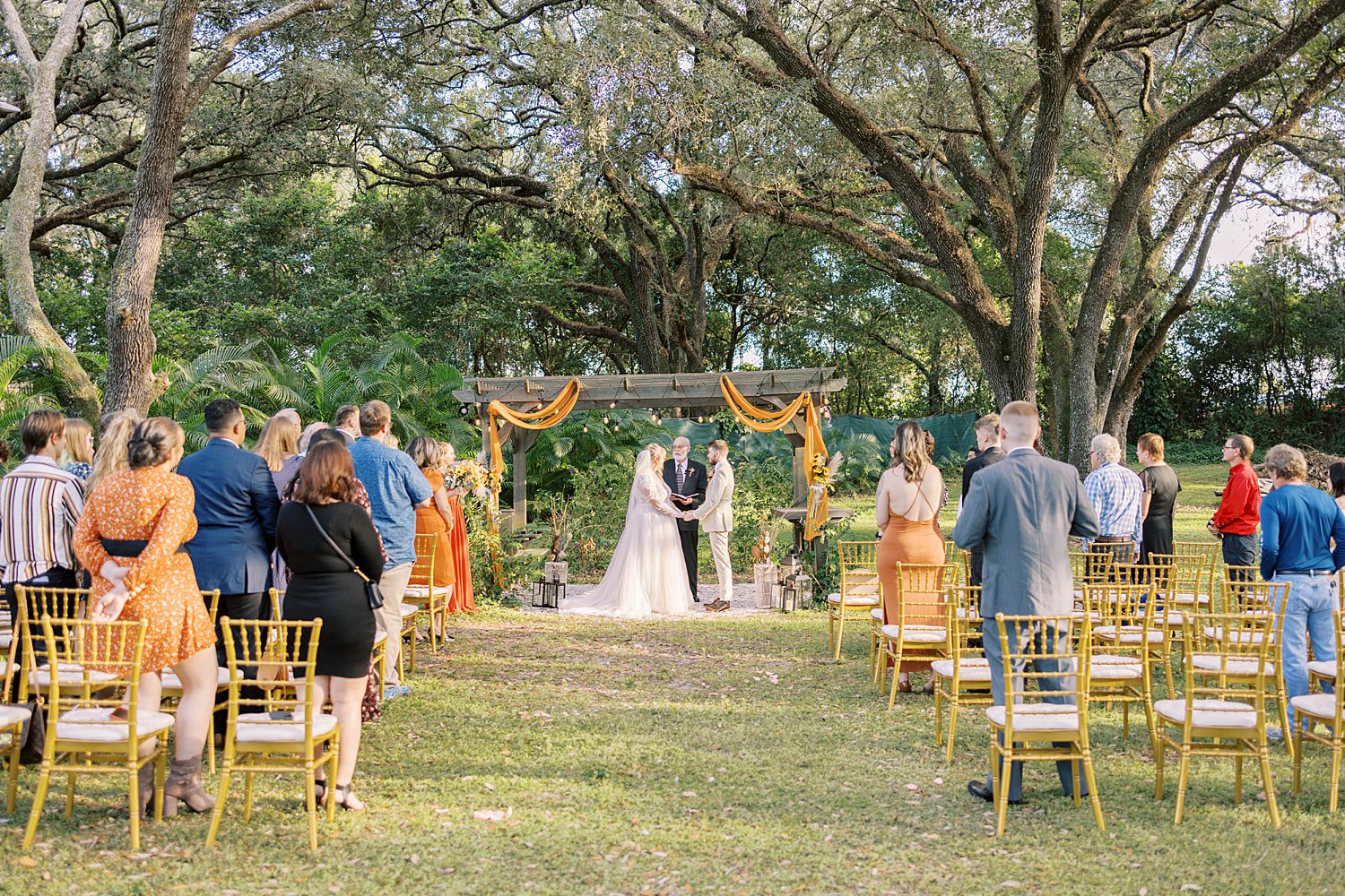 couple exchanges vows during Events Under the Oaks wedding ceremony