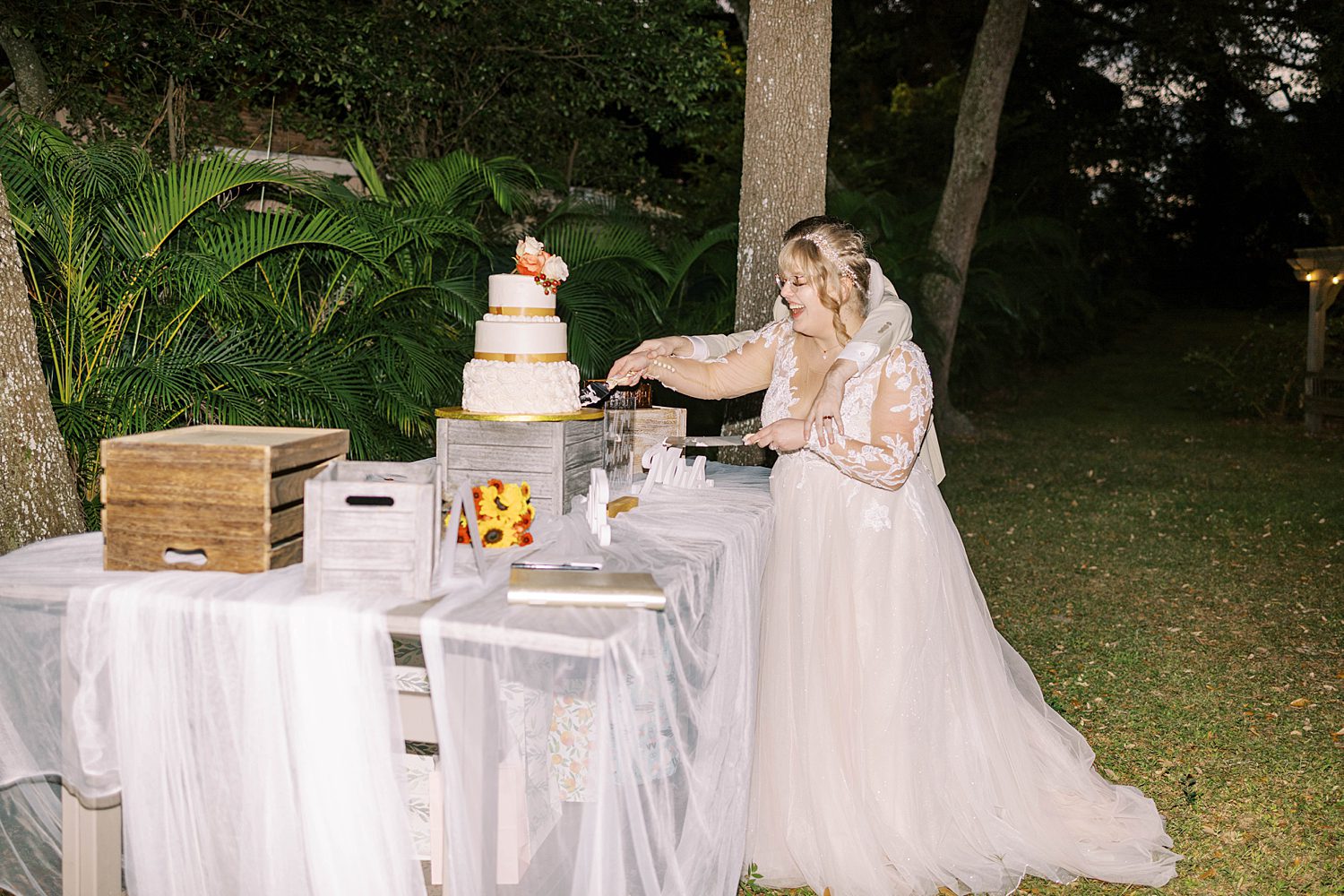 newlyweds cut wedding cake during Tampa FL wedding reception 