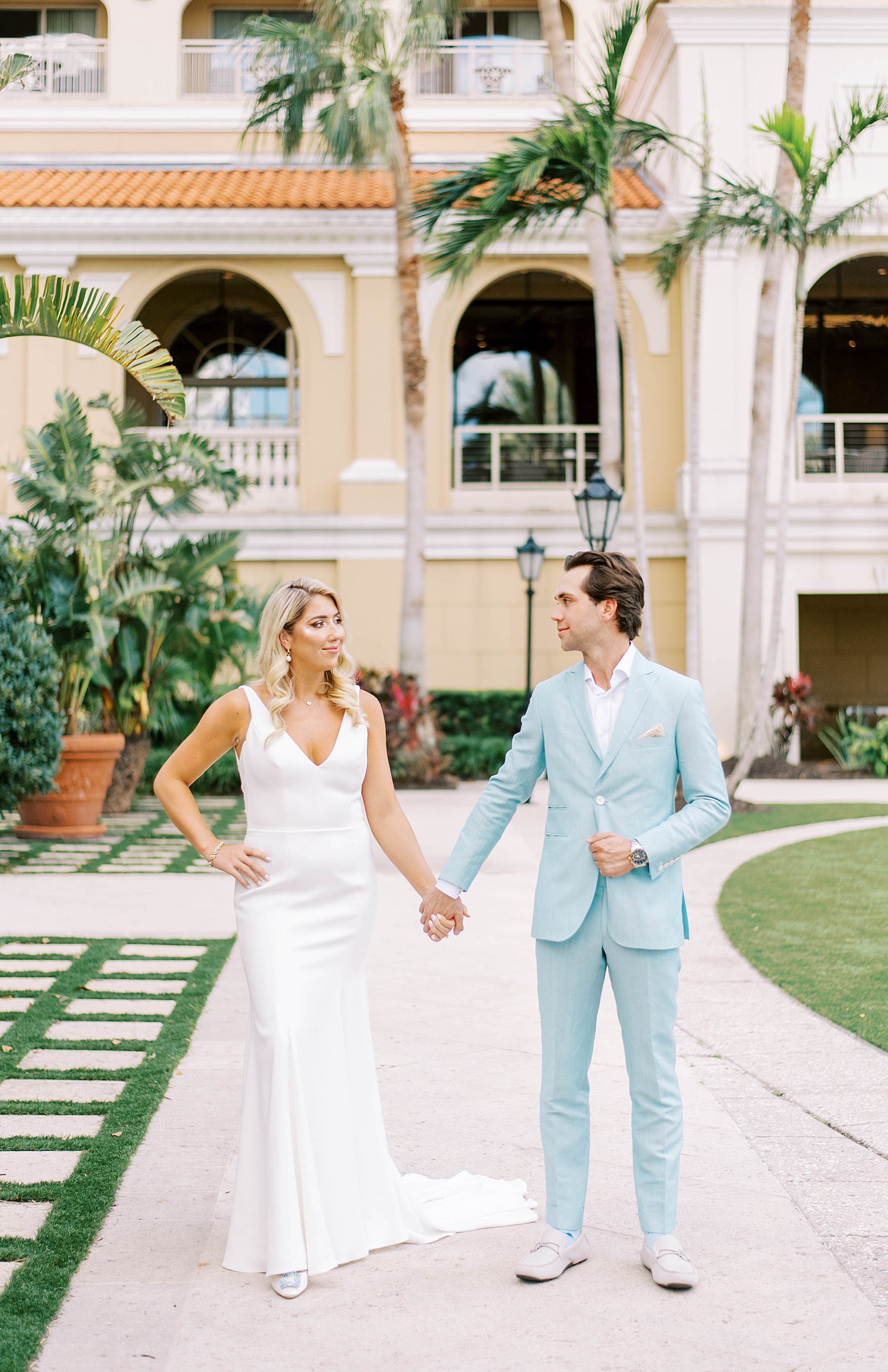 high fashion wedding day at Ritz Carlton Sarasota with bride in custom gown and groom in blue tux