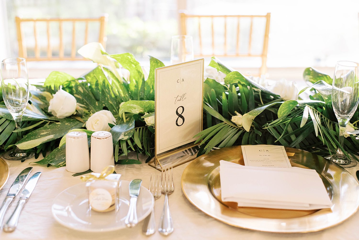 tropical place settings with white flowers and greenery at Ritz Carlton Sarasota