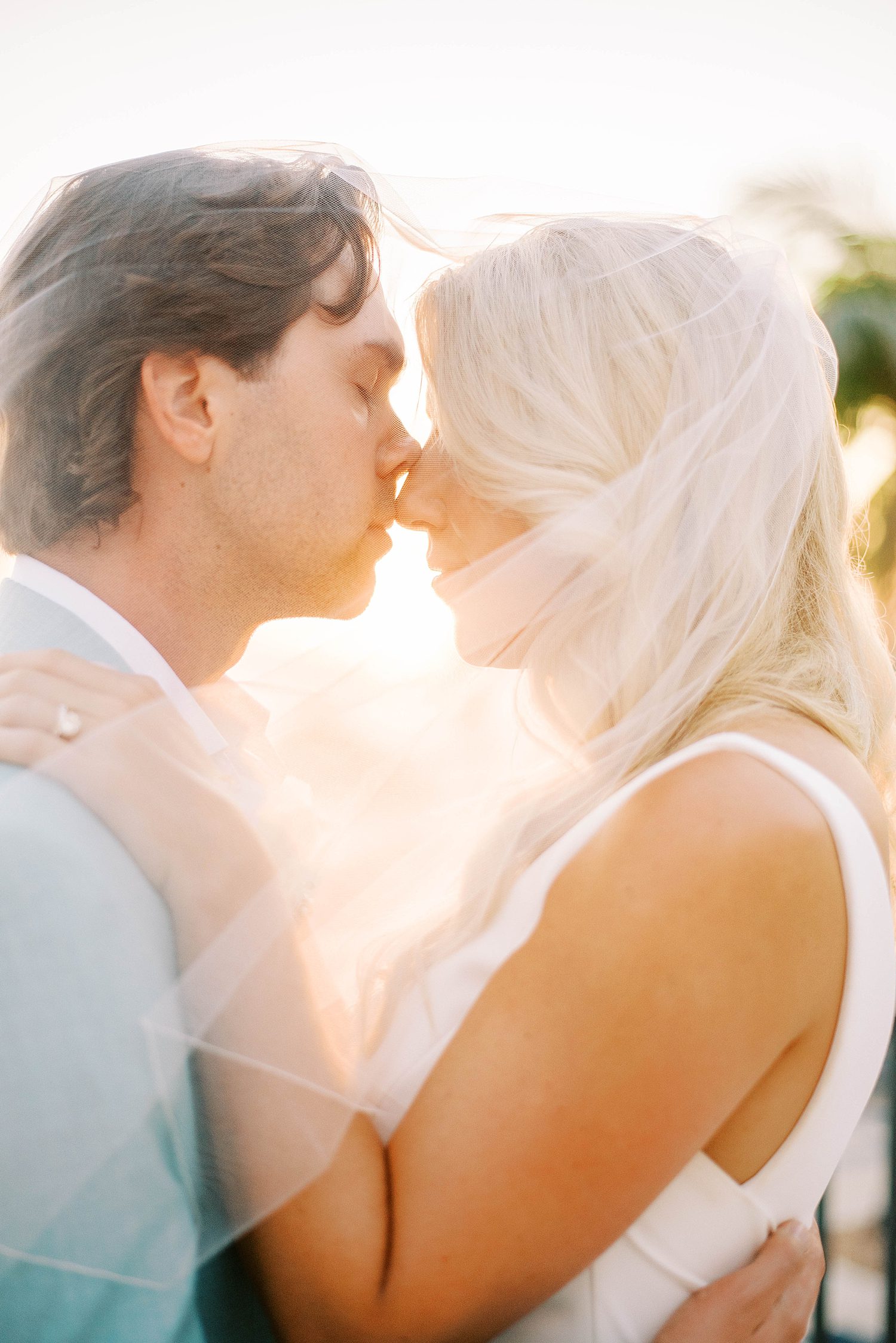 groom kisses bride's nose during portraits at the Ritz Carlton Sarasota