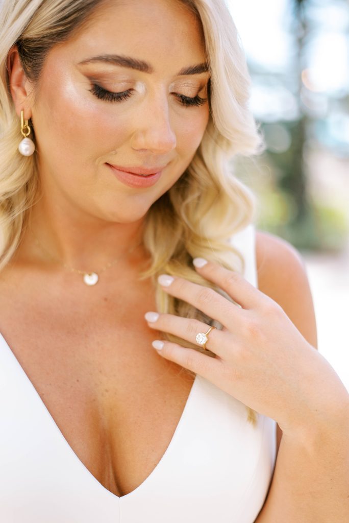 bride puts hand on shoulder showing off engagement ring
