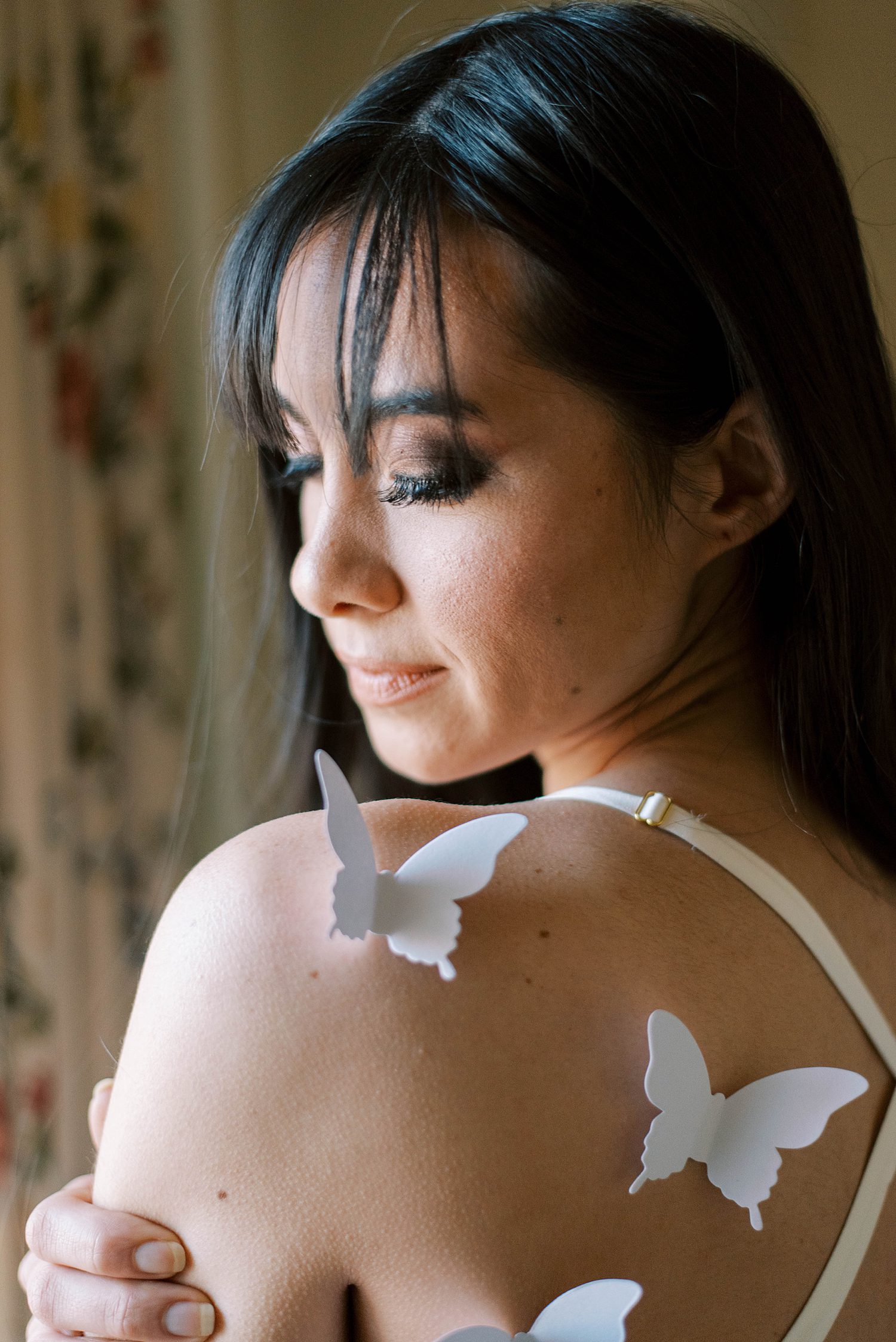 bride looks at shoulder with butterflies