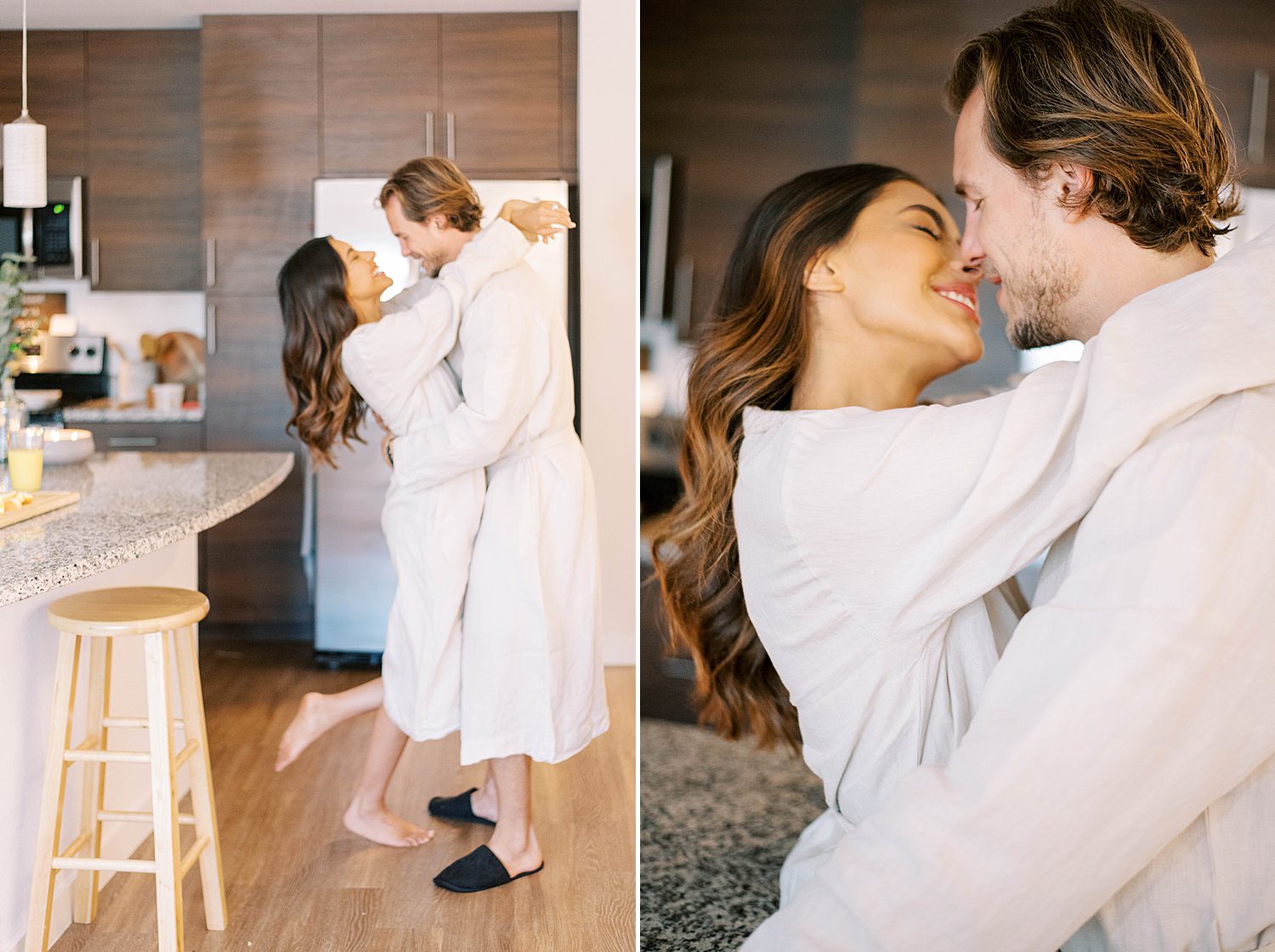 woman leans to kiss husband while wearing robes dancing in kitchen