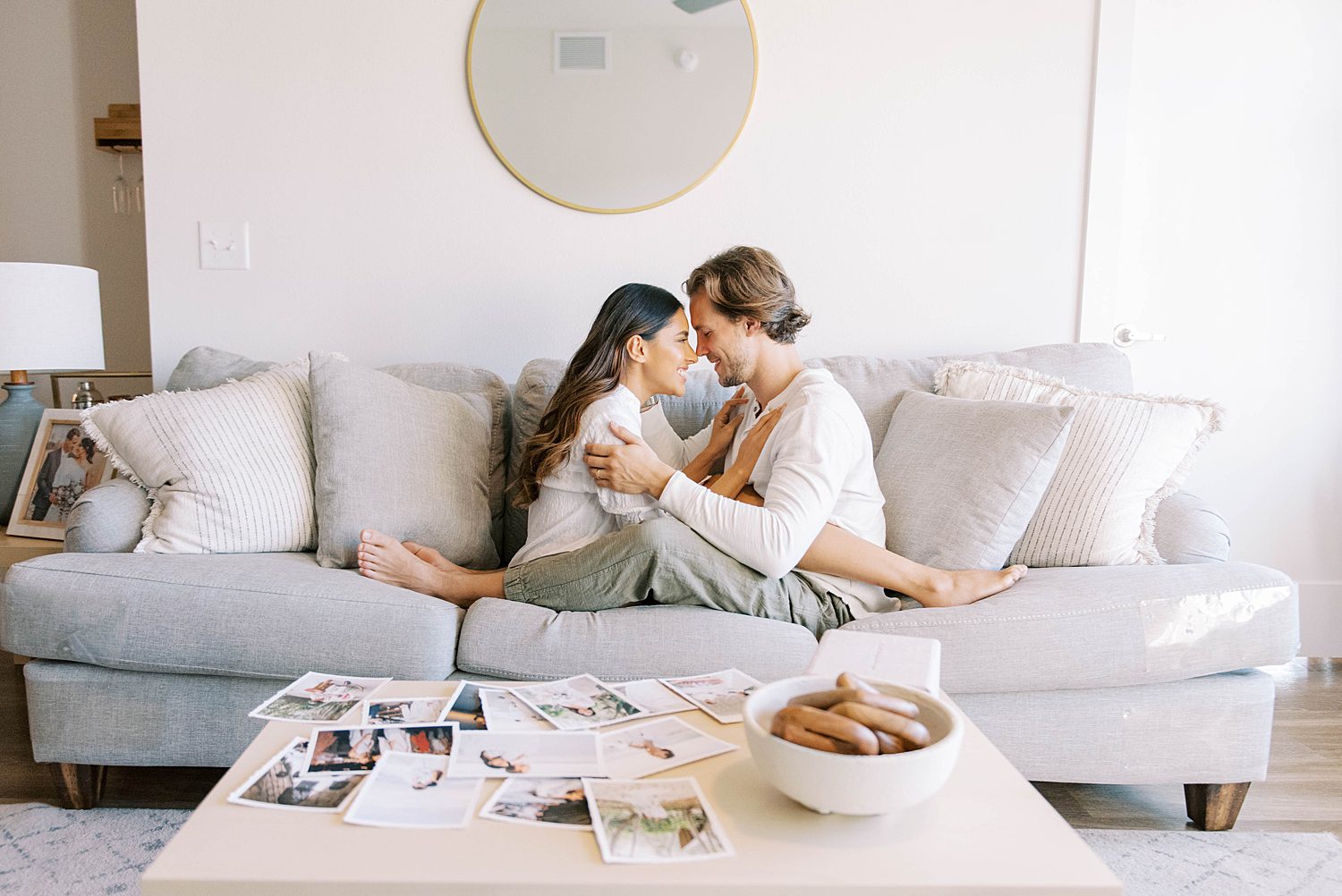 married couple sits together on couch during lifestyle photos