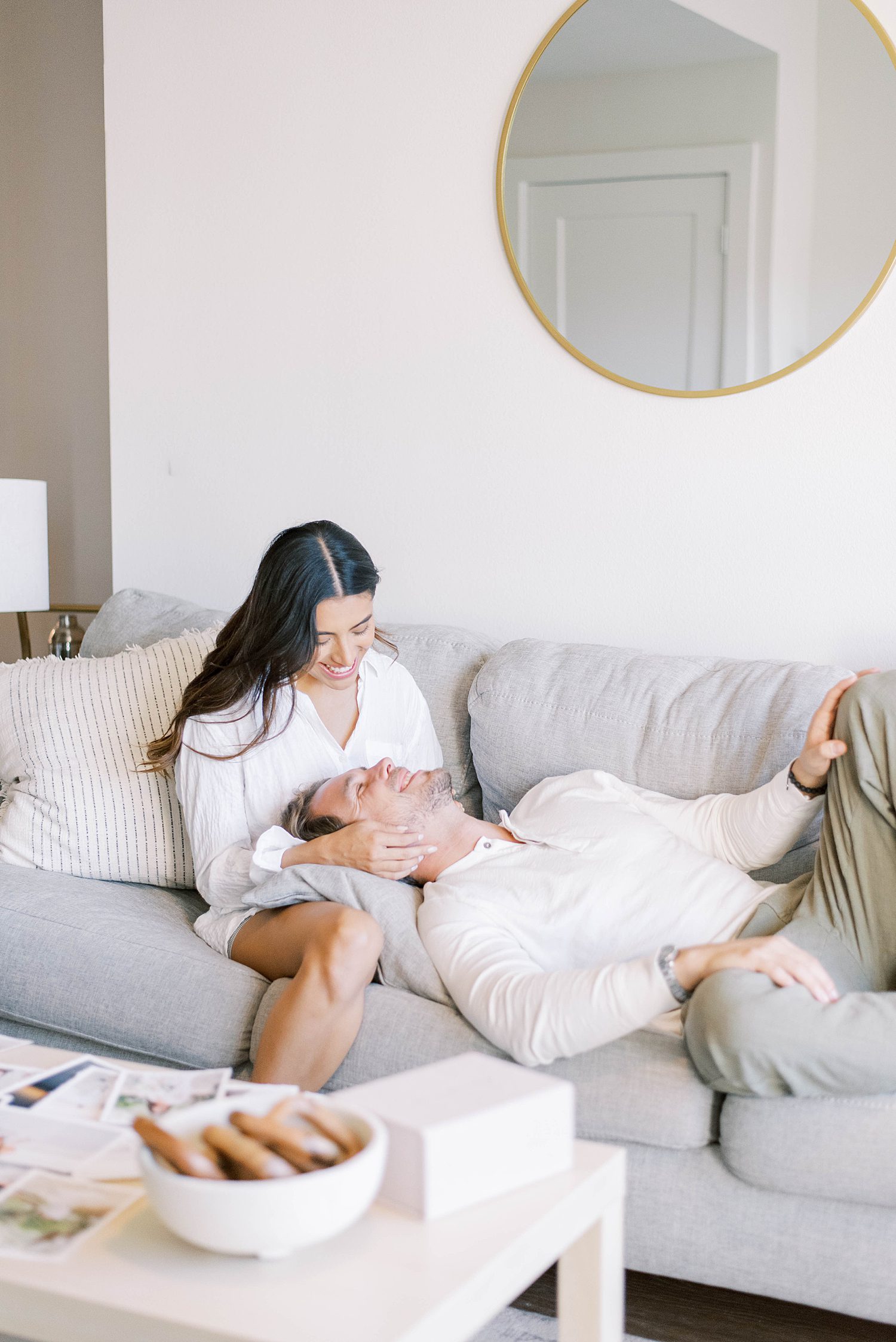 man lays back on wife's lap during lifestyle anniversary portraits