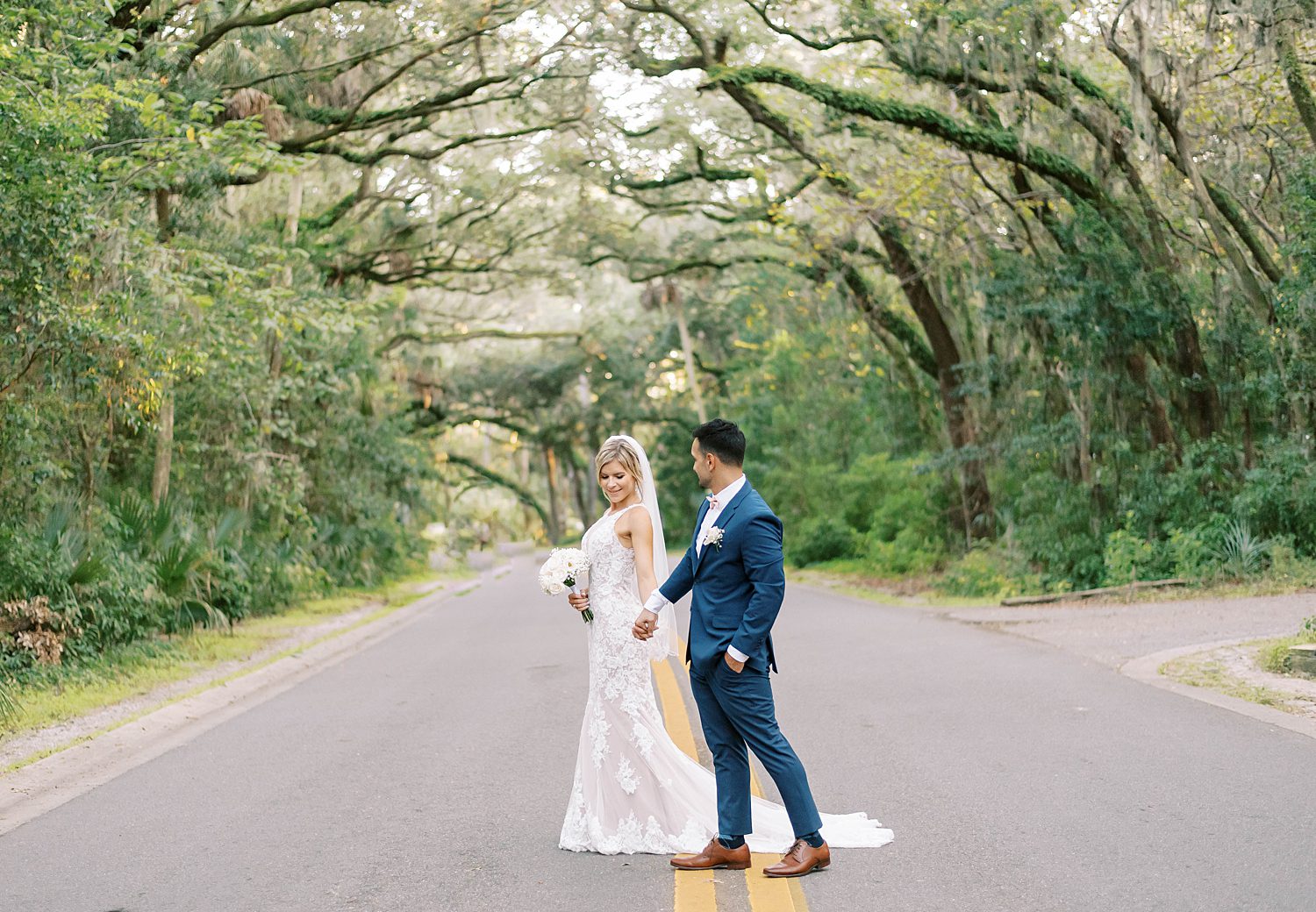 bride and groom walk together during intimate Tampa microwedding at Philippe Park