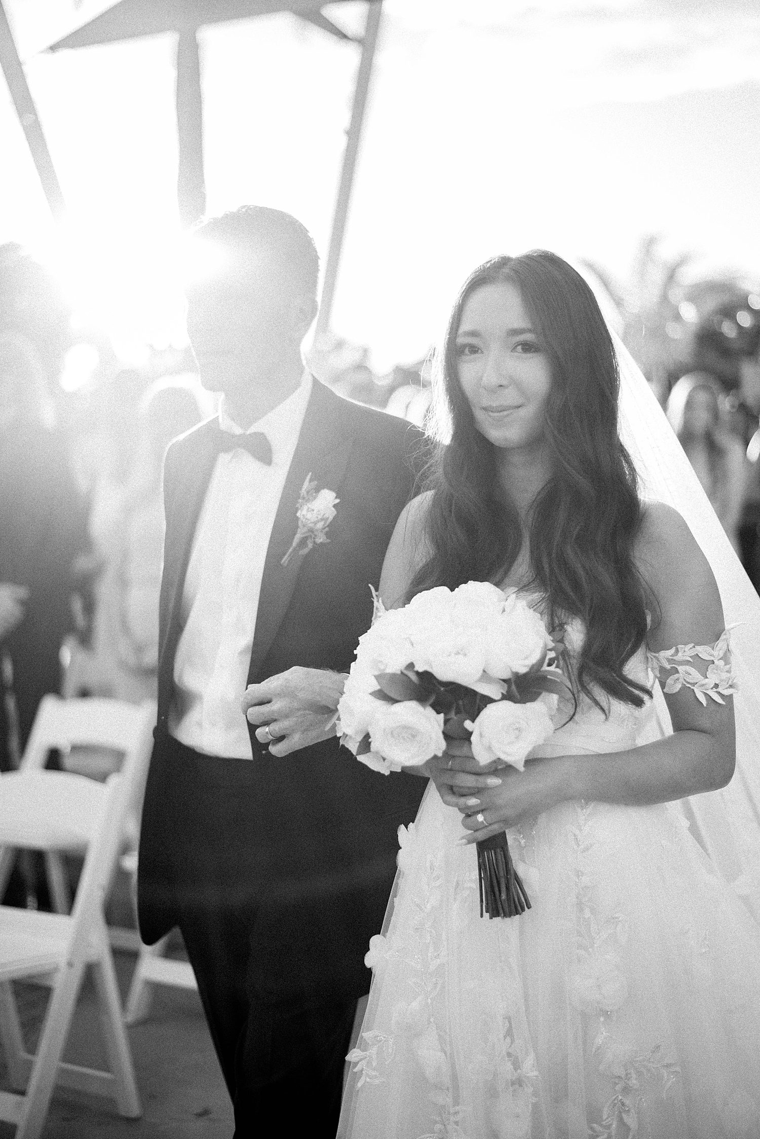 bride walks down aisle for ceremony at Sarasota Yacht Club