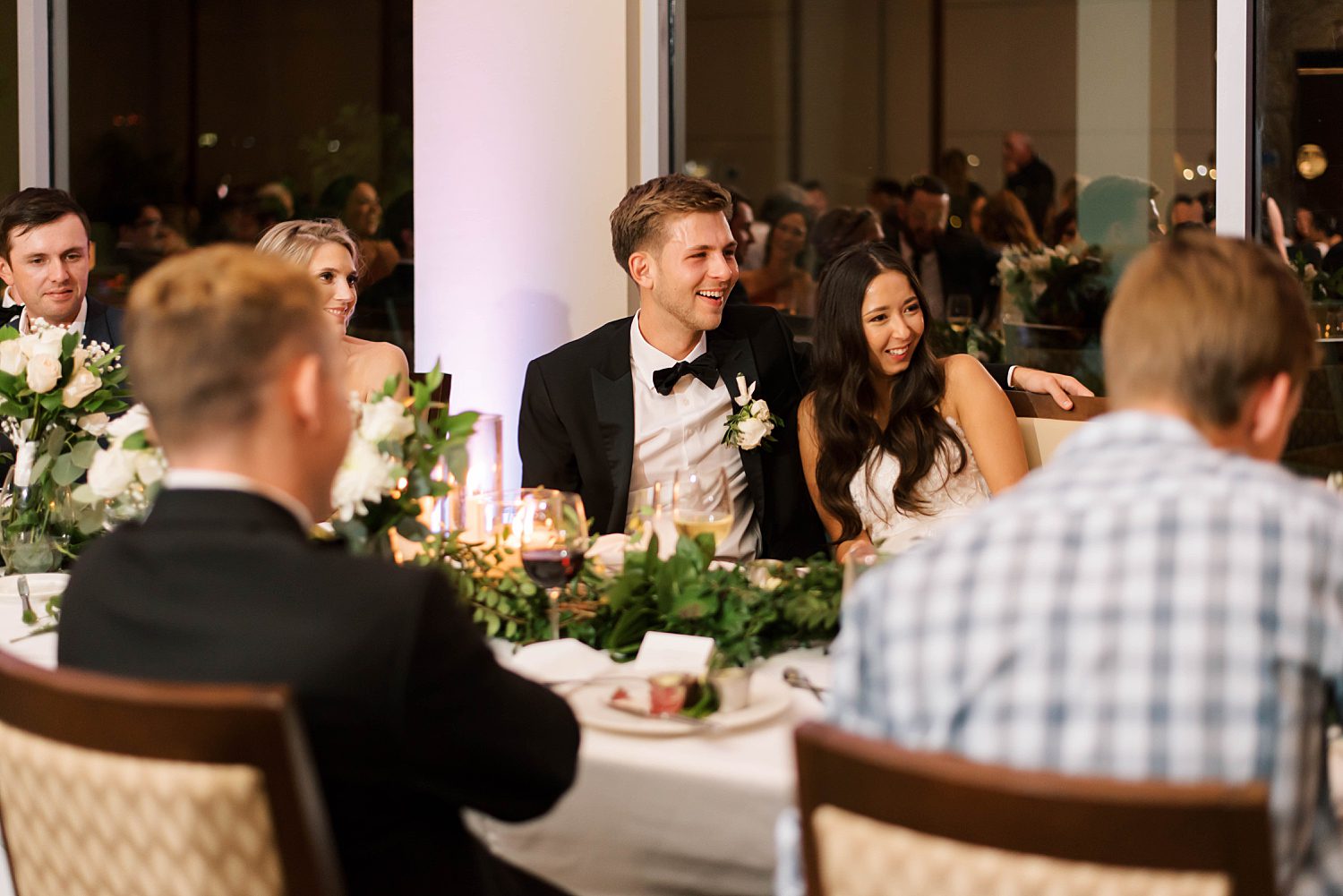 couple laughs during speeches at Sarasota Yacht Club