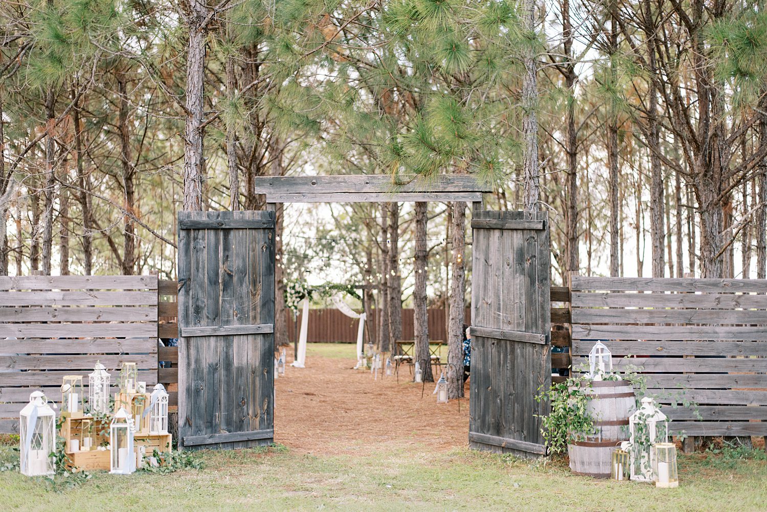 outdoor ceremony site with wooden doors at The Barn at Lone Oak Acres