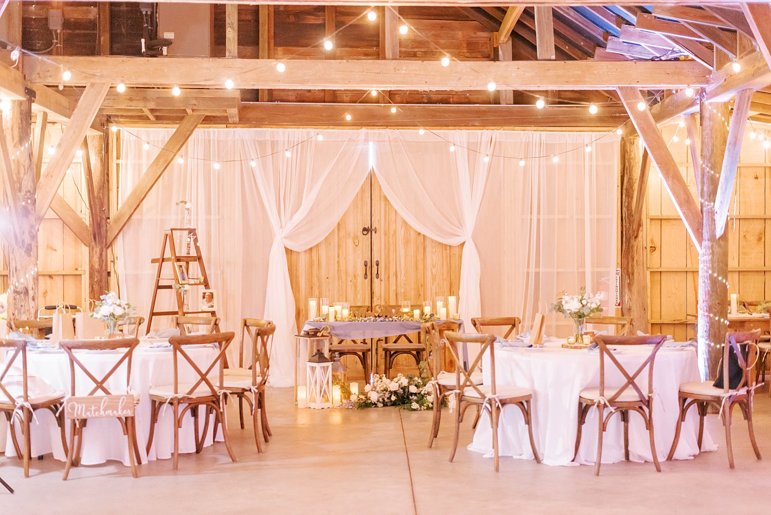 rustic reception at The Barn at Lone Oak Acres with white fabric hanging