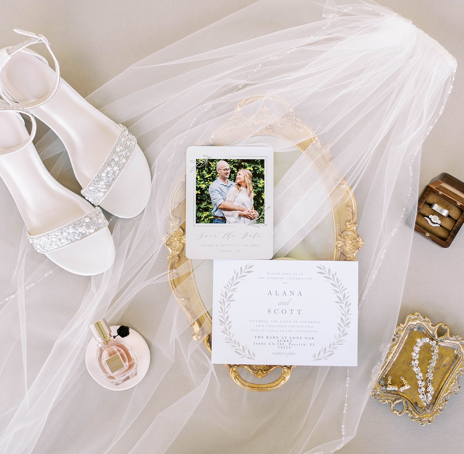 wedding details and bride's shoes lay on veil