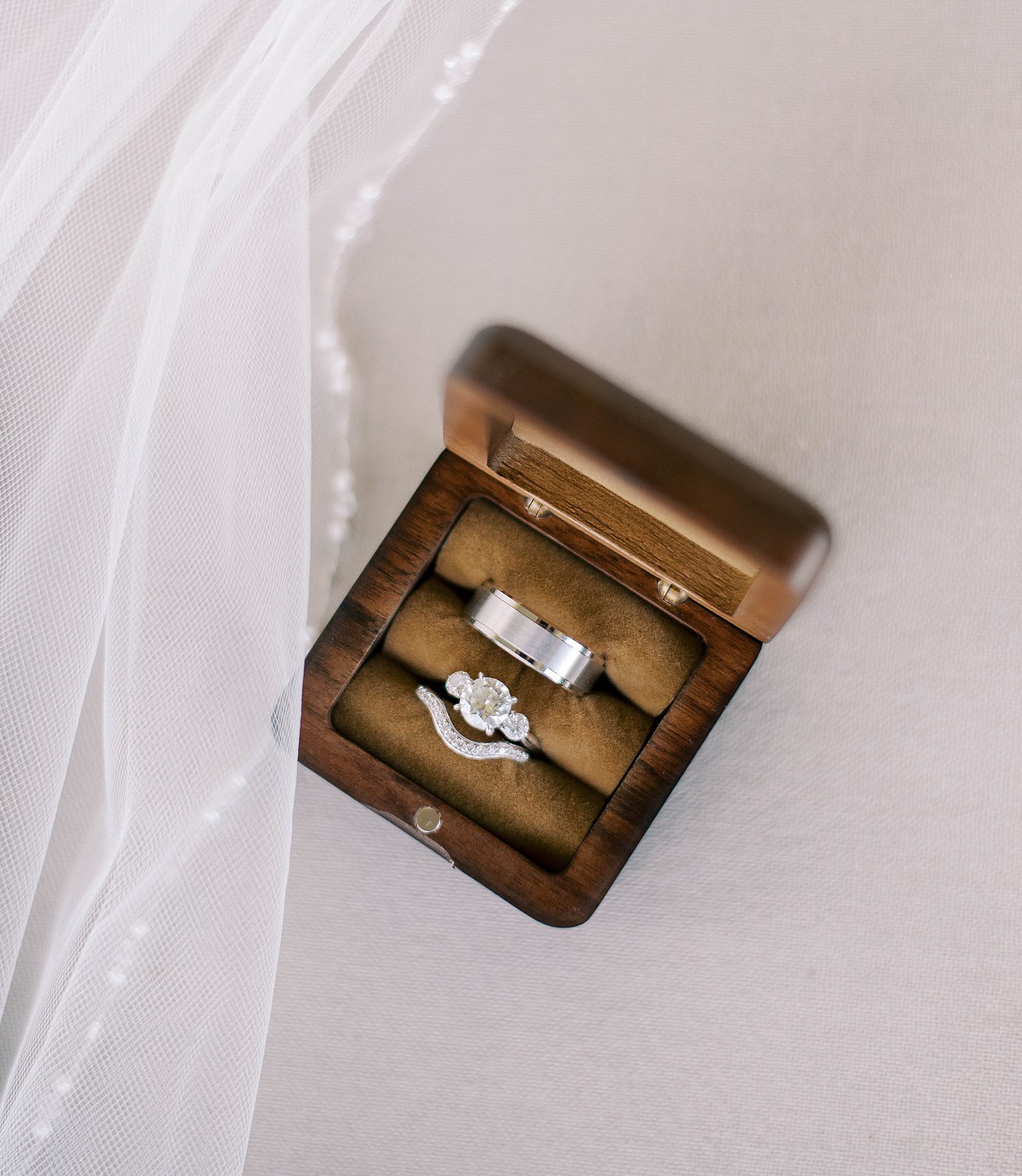 wedding rings in wooden box at The Barn at Lone Oak Acres