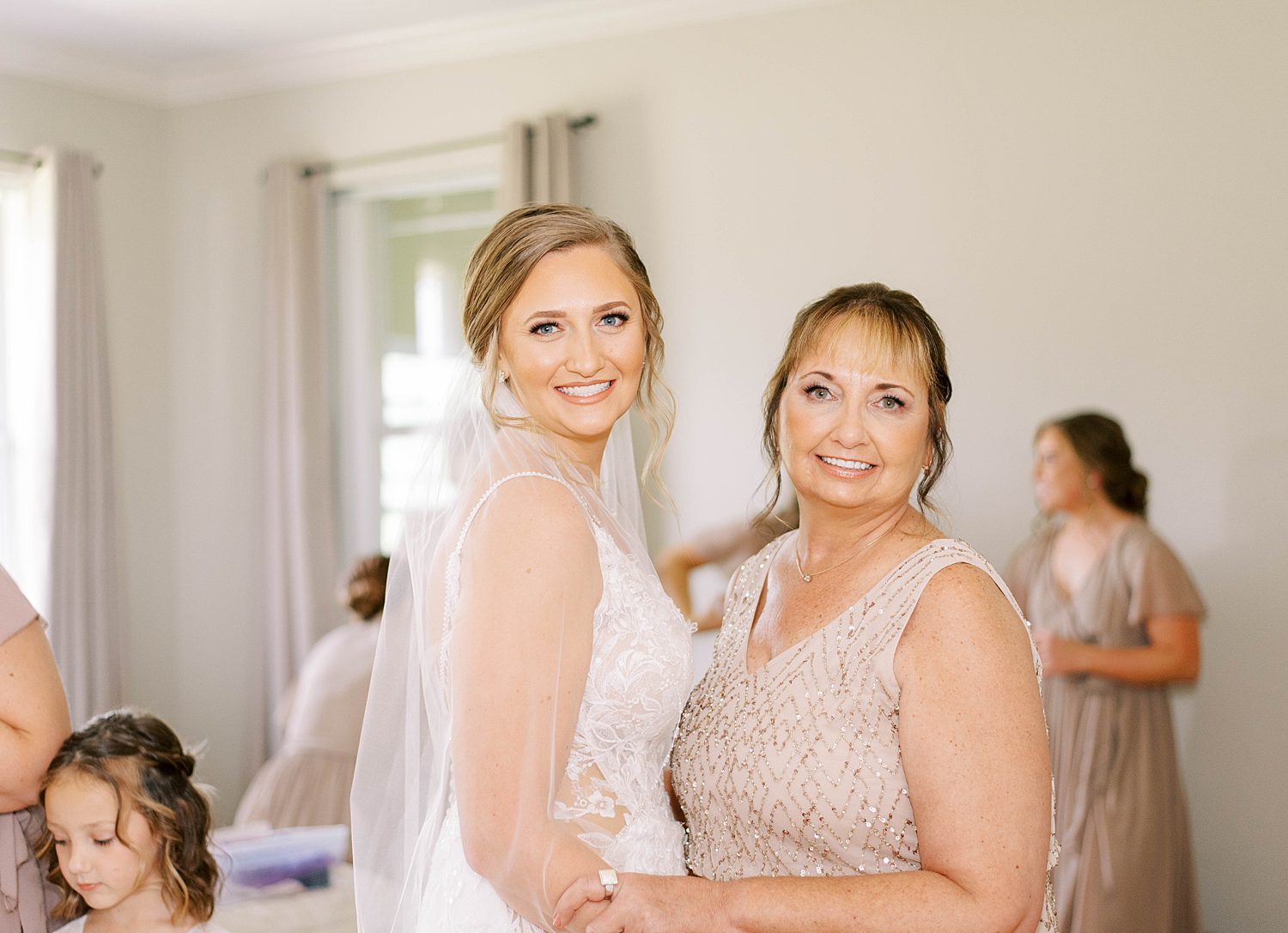 bride hugs mother during prep at The Barn at Lone Oak Acres