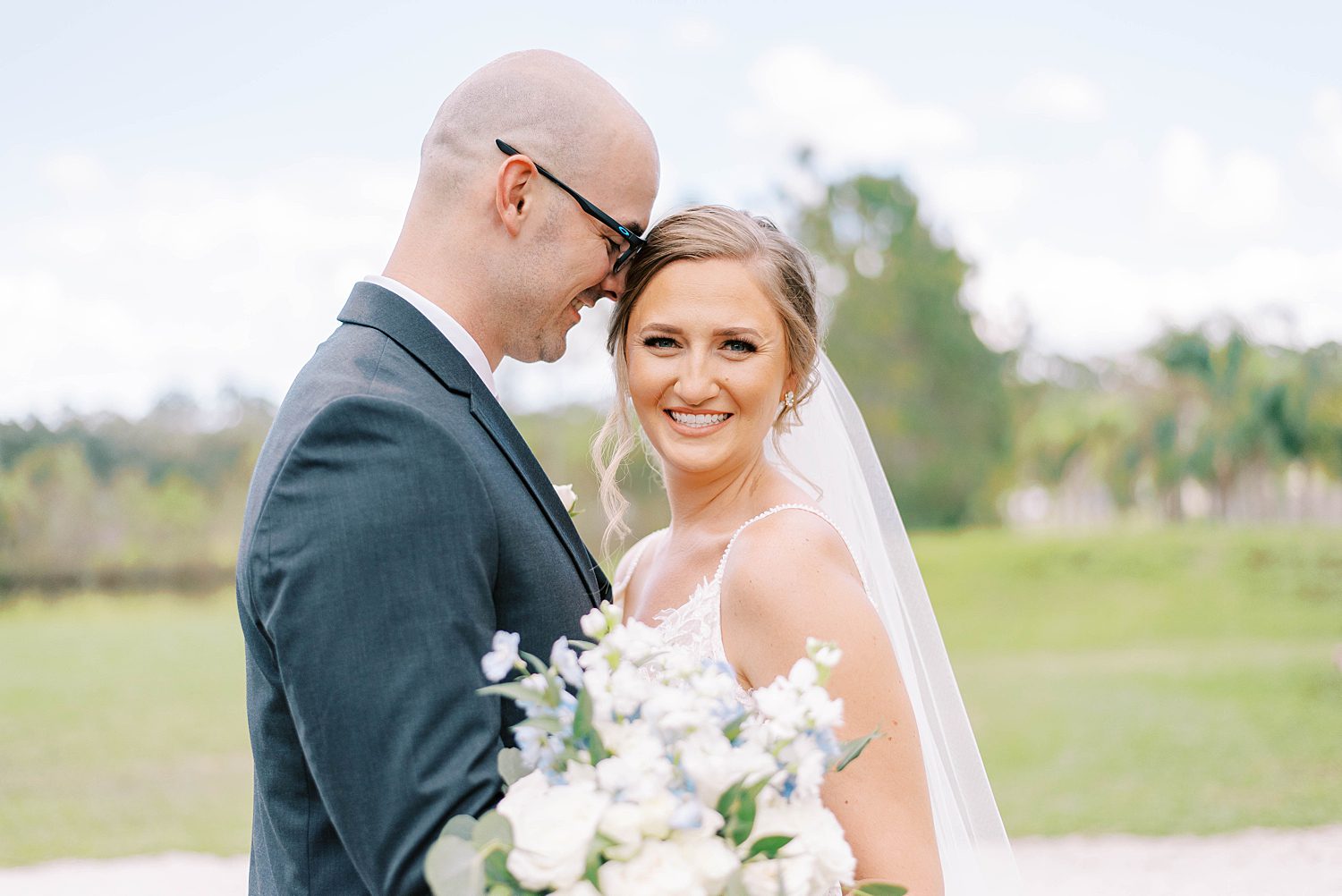 groom nuzzles bride's forehead at The Barn at Lone Oak Acres