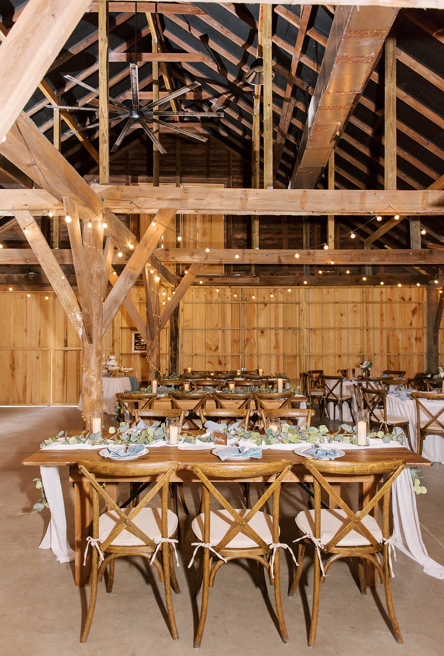reception table with family style seating and lace table runner at The Barn at Lone Oak Acres