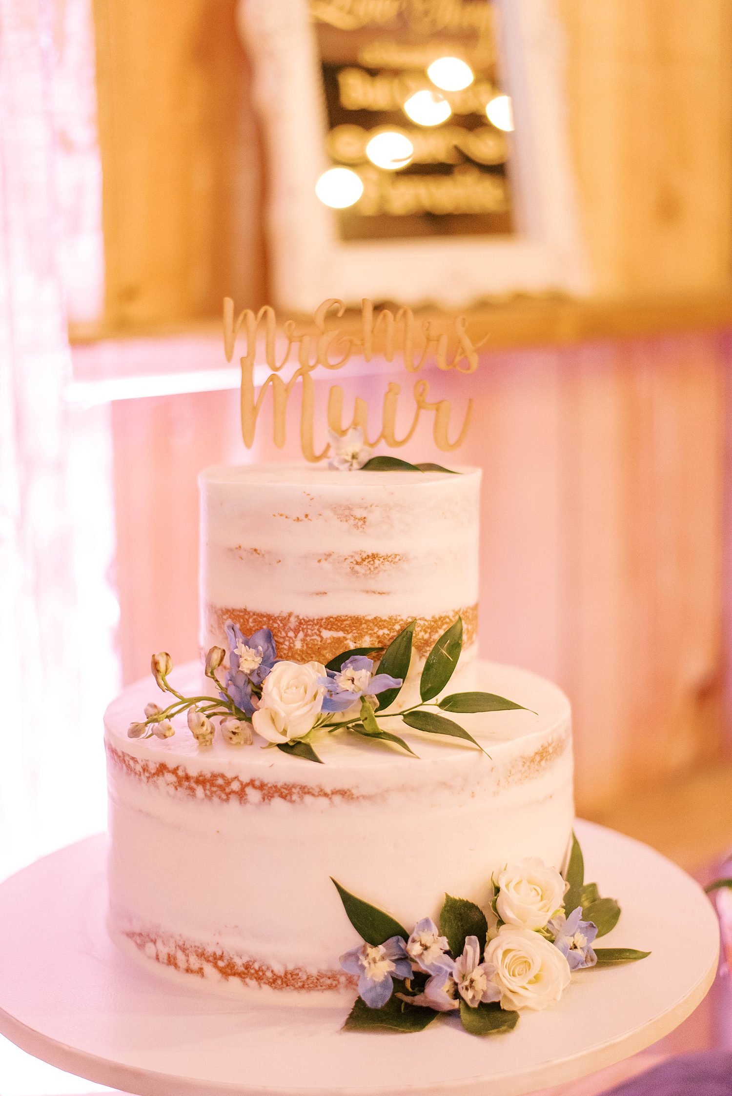 naked wedding cake with leaf accents