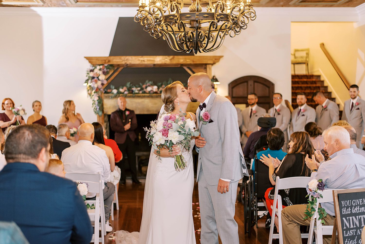 bride and groom kiss in the aisle walking up after ceremony in Orlando FL