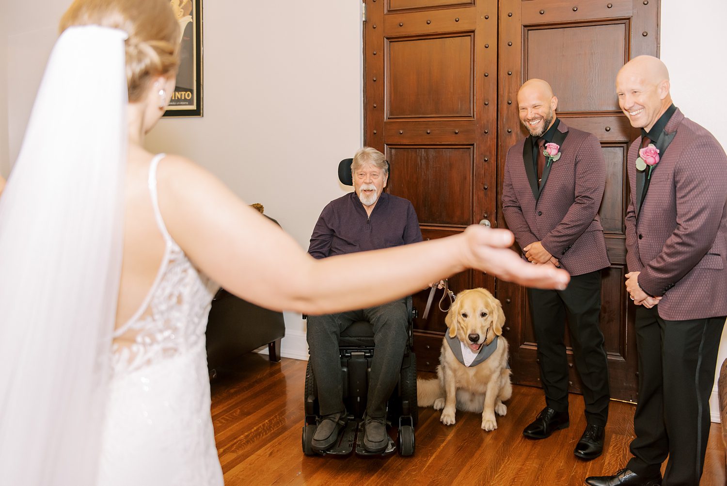 bride shows father and brothers gown during first look