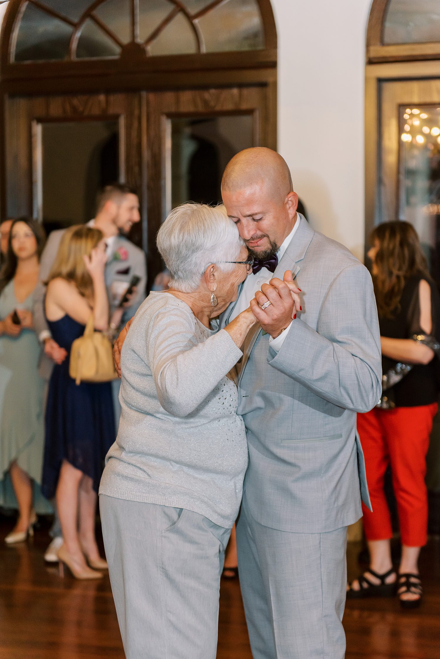 groom dances with mother during Orlando wedding reception