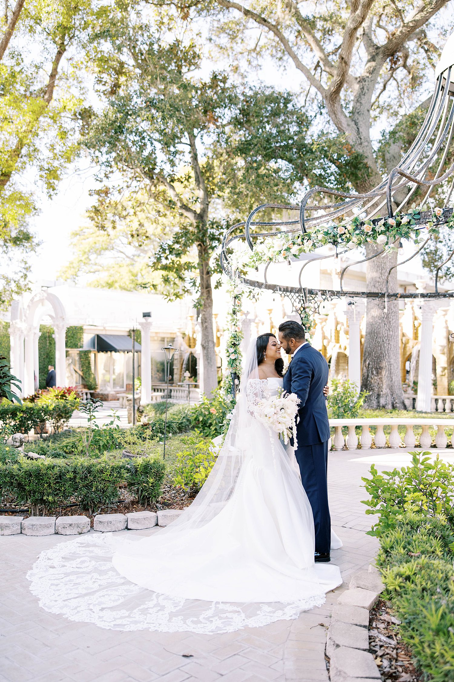 bride and groom kiss in gardens of Kapok Special Events