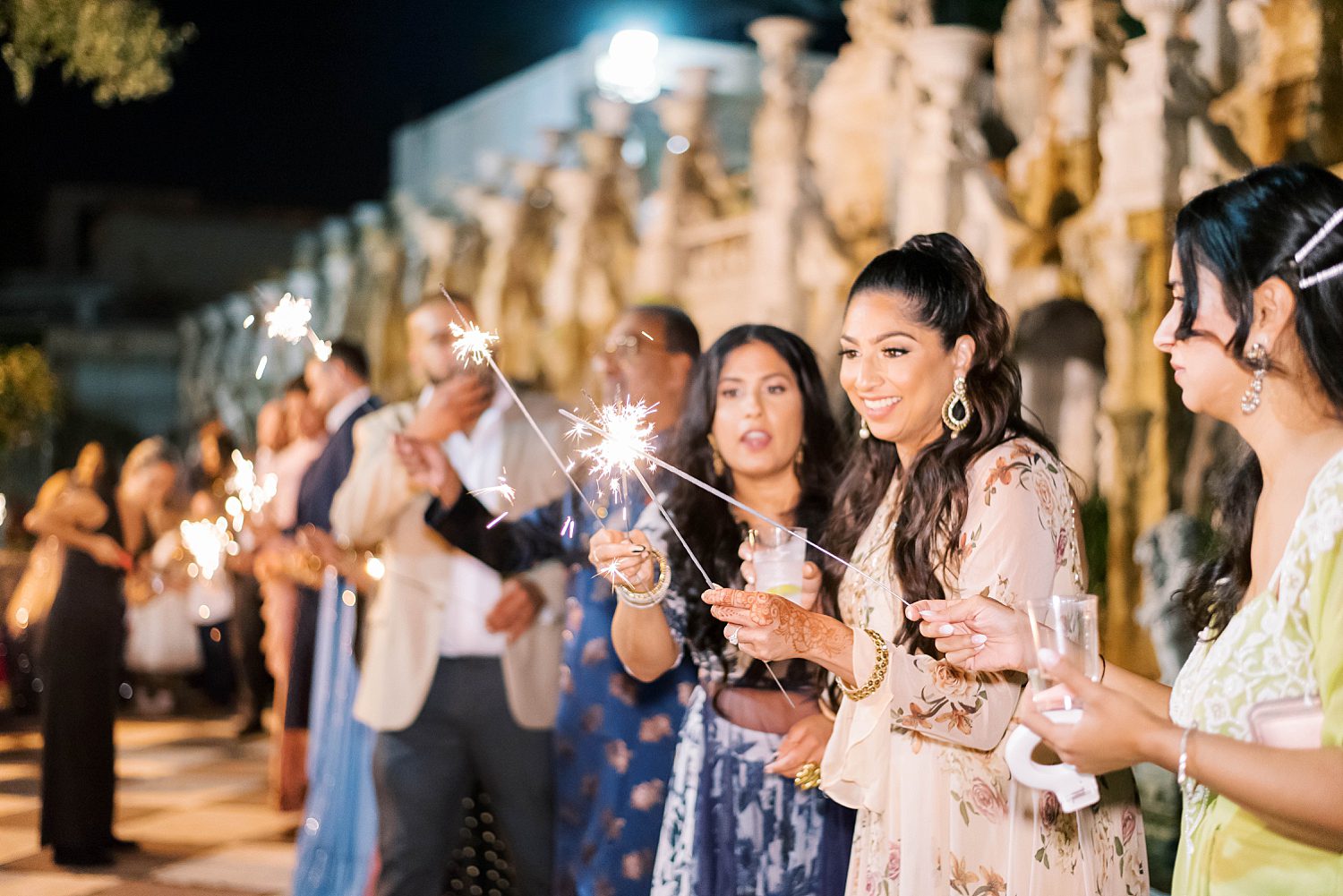 women light sparklers outside Kapok Special Events