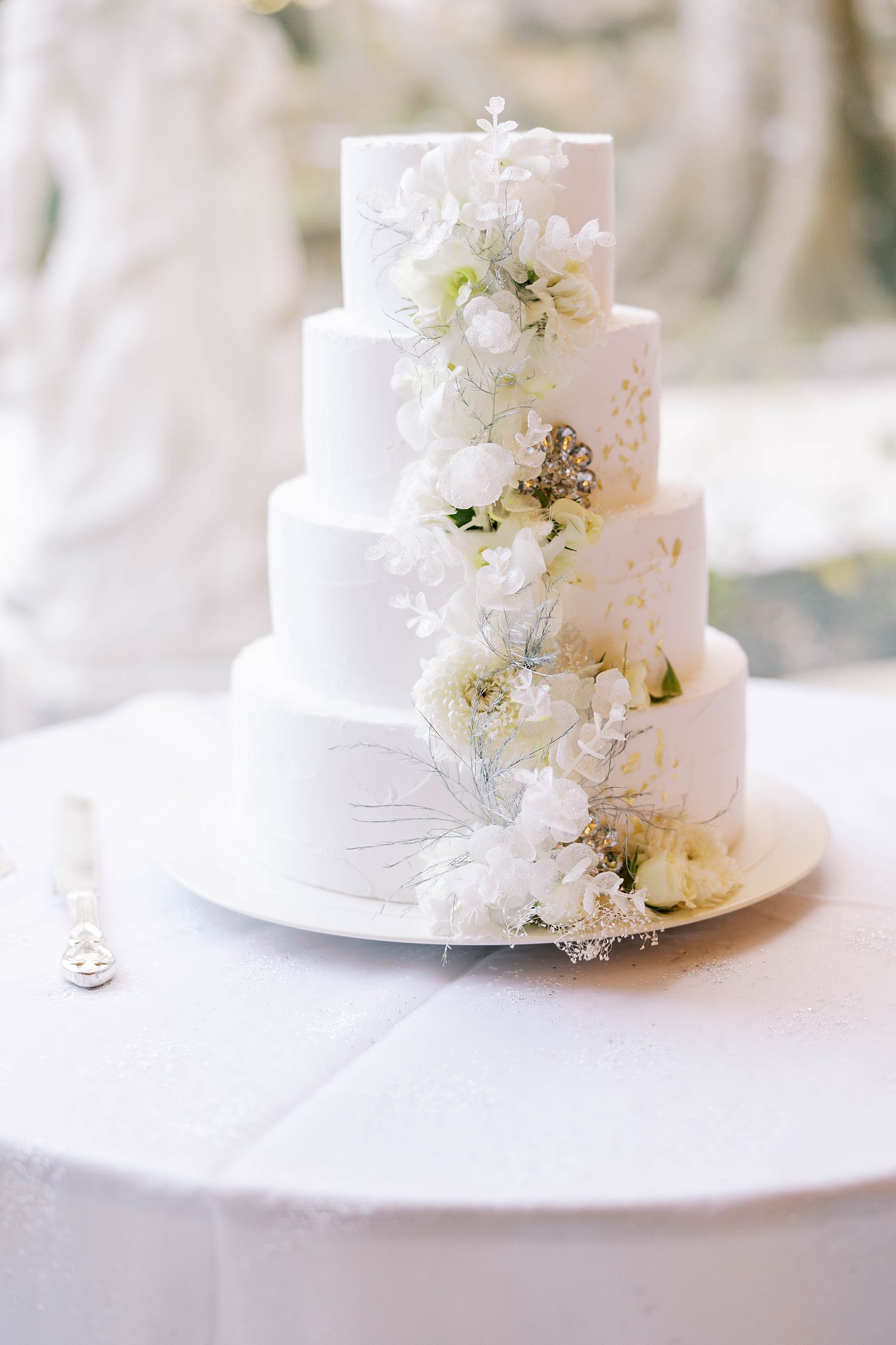 tiered wedding cake with white florals down side