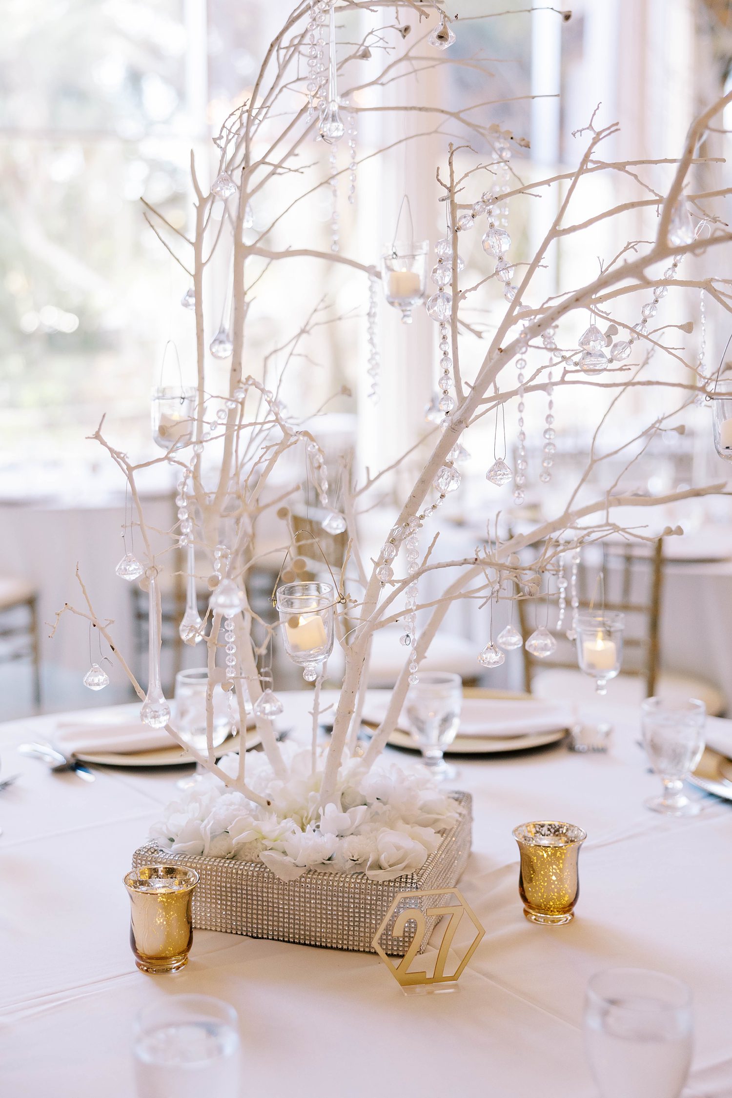 tree with glass ornaments and gold candles for winter wedding reception at Kapok Special Events