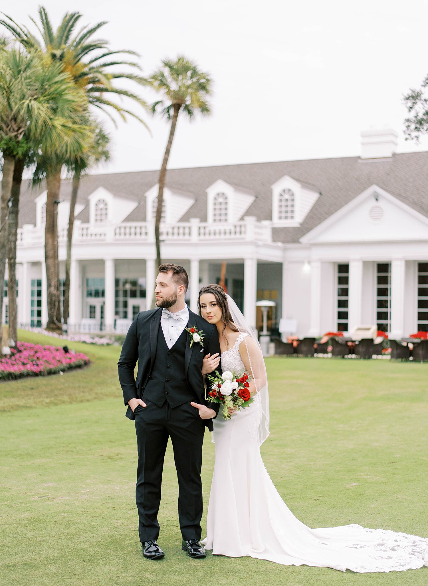 bride and groom pose on lawn at Palma Ceia Country Club