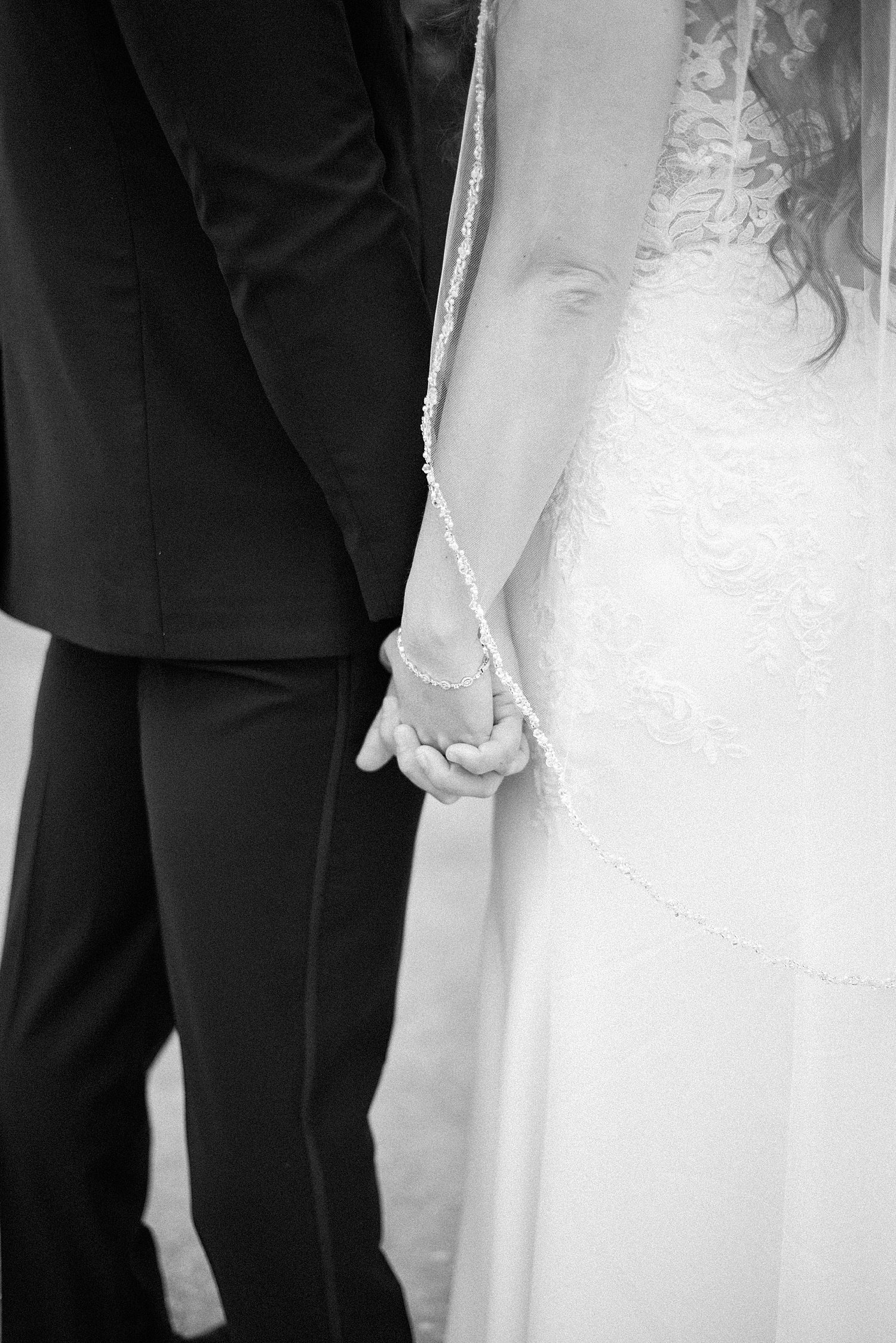 newlyweds hold hands during FL wedding photos 