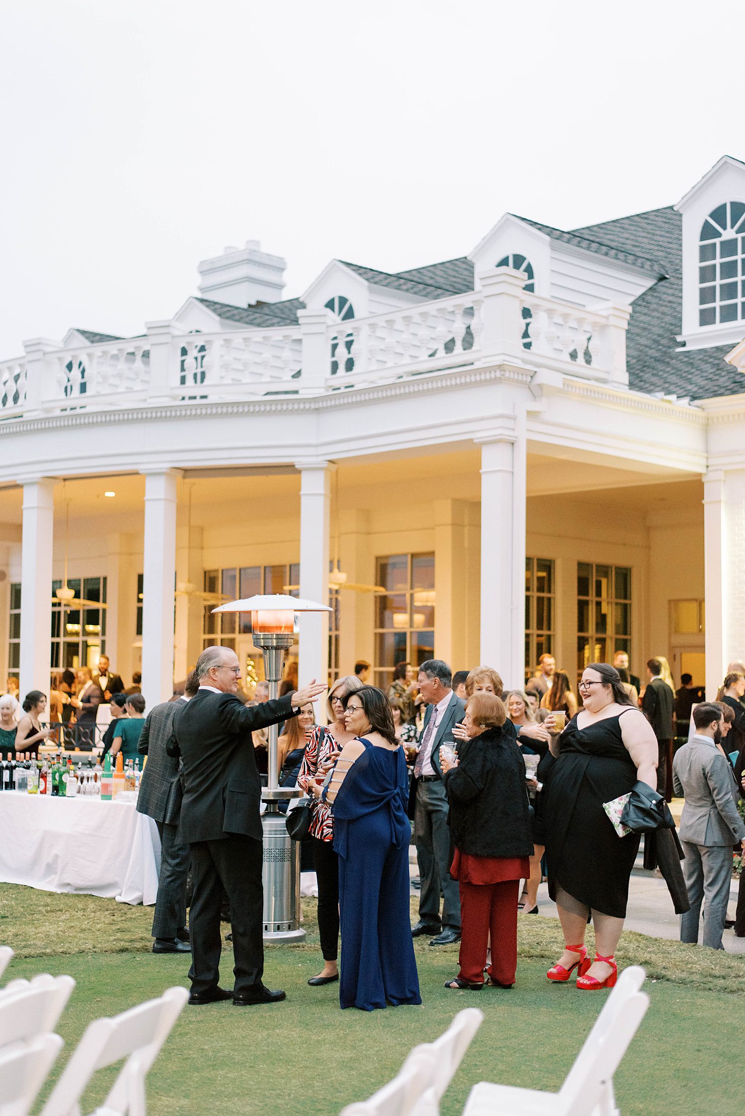 guests mingle on lawn before ceremony at Palma Ceia Country Club