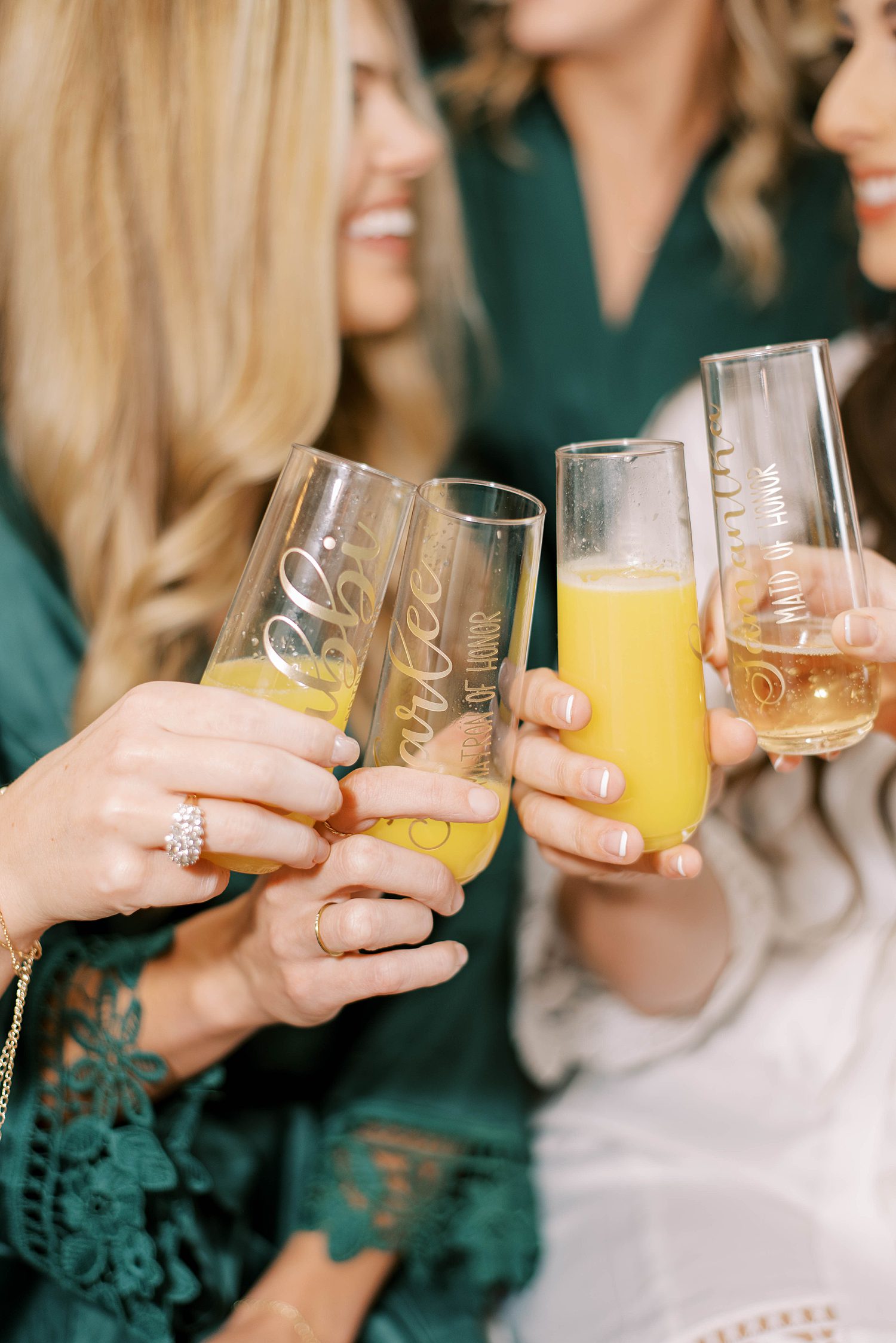bride and bridesmaids toast mimosas