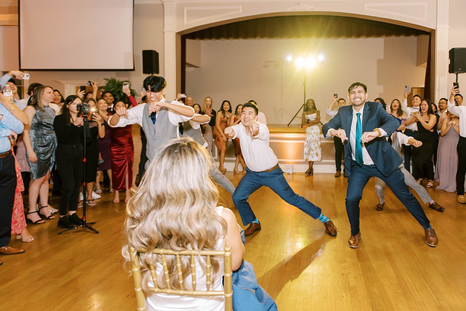 groom dances with friends at Higgins Hall for bride 