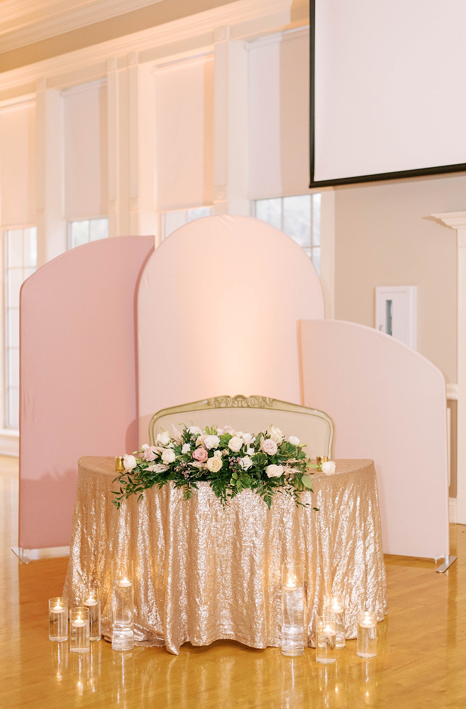 sweetheart table with large pink displays at Higgins Hall